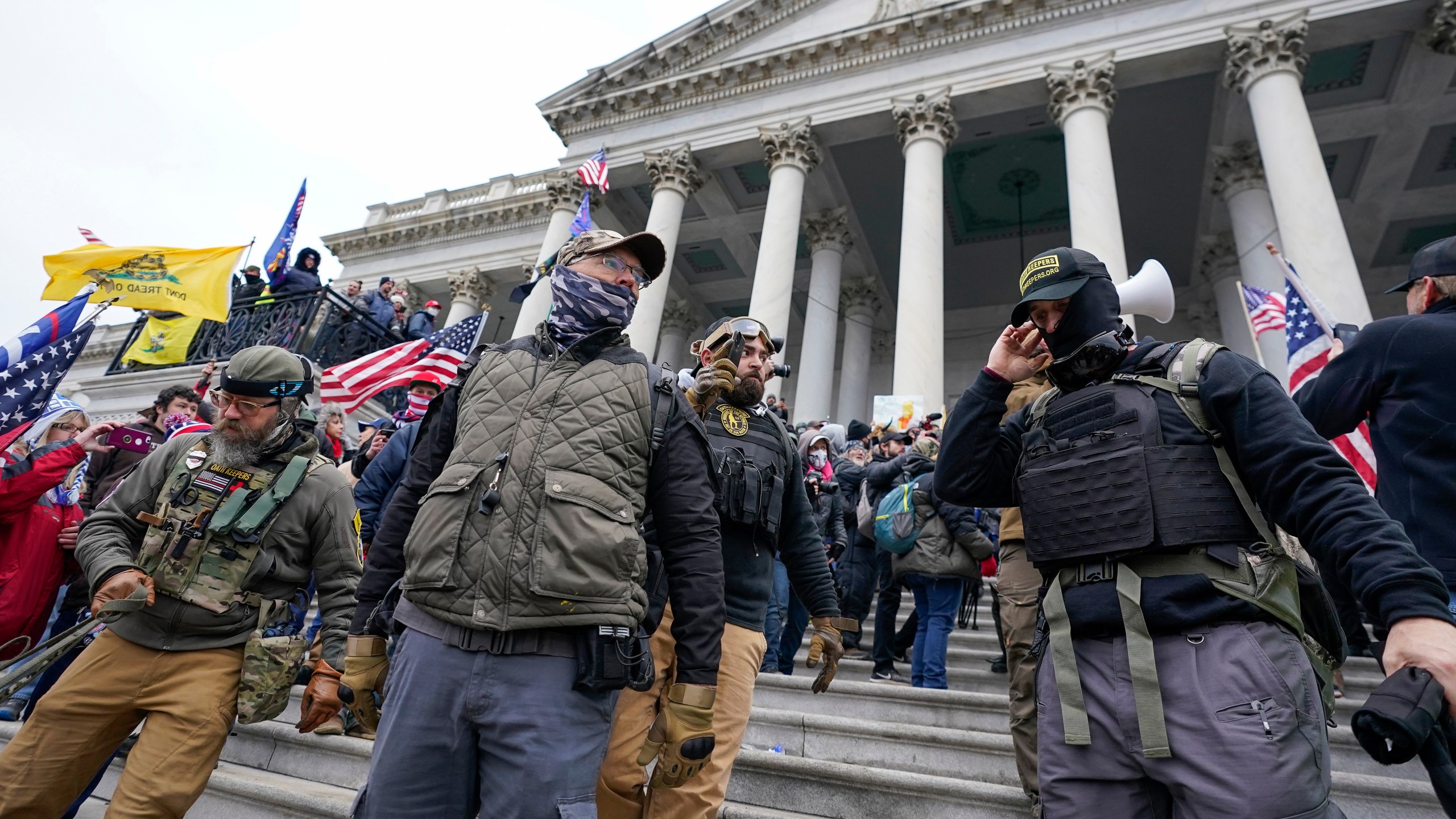 FILE - Members of the Oath Keepers extremist group stand on the East Front of the U.S. Capitol on Jan. 6, 2021, in Washington. David Moerschel, a 45,-year-old neurophysiologist from Punta Gorda, Fla., and Joseph Hackett, a 52-year-old chiropractor from Sarasota, Fla., who stormed the U.S. Capitol with other members of the far-right Oath Keepers group, were sentenced Friday to three years in prison for seditious conspiracy and other charges, the latest in a historic string of sentences in the Jan. 6. 2021 attack. (AP Photo/Manuel Balce Ceneta, File)