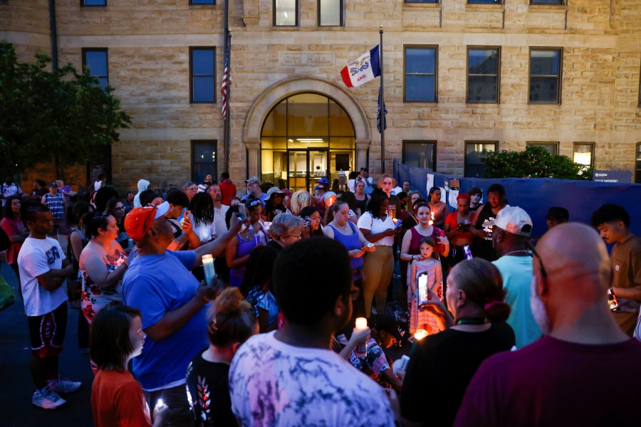 Community members gather for a candlelight vigil for Branden Colvin Sr., Ryan Hitchcock and Daniel Prien outside Davenport City Hall, Sunday, June 4, 2023, in Davenport, Iowa. The three men had been missing since the partial collapse of an apartment building on May 28. Colvin has since been confirmed to have died in the collapse. (Nikos Frazier/Quad City Times via AP)