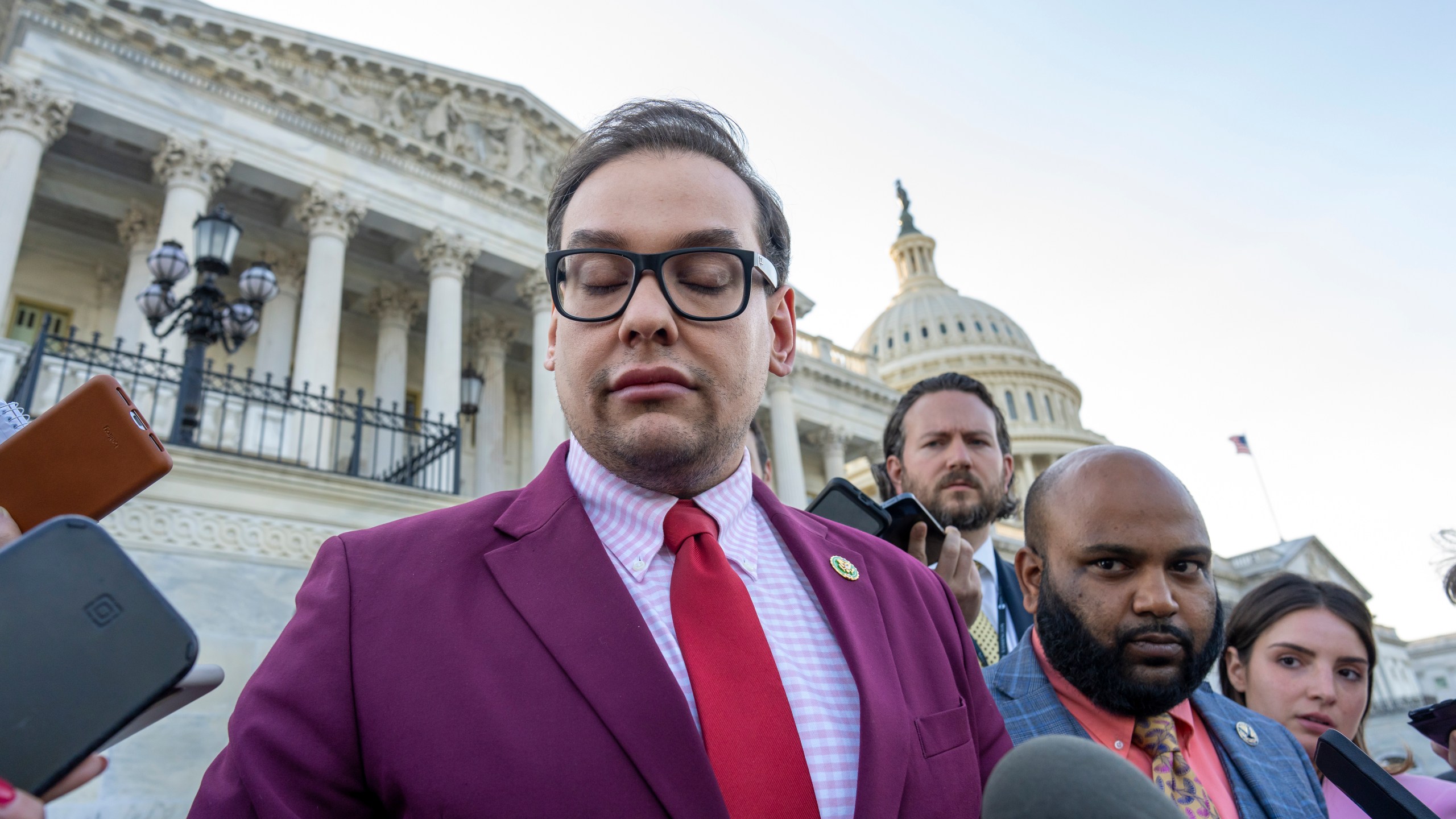 FILE - Rep. George Santos, R-N.Y., speaks to reporters outside the Capitol, as his top political aide Vish Burra, second from right, listens, after an effort to expel Santos from the House, in Washington, Wednesday, May 17, 2023. A man who briefly worked as an aide to Santos told House investigators Wednesday, May 31, that he got his job after sending a series of payments to Burra, Santos' director of operations. (AP Photo/J. Scott Applewhite, File)