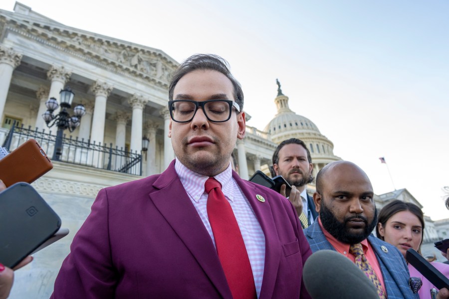 FILE - Rep. George Santos, R-N.Y., speaks to reporters outside the Capitol, as his top political aide Vish Burra, second from right, listens, after an effort to expel Santos from the House, in Washington, Wednesday, May 17, 2023. A man who briefly worked as an aide to Santos told House investigators Wednesday, May 31, that he got his job after sending a series of payments to Burra, Santos' director of operations. (AP Photo/J. Scott Applewhite, File)