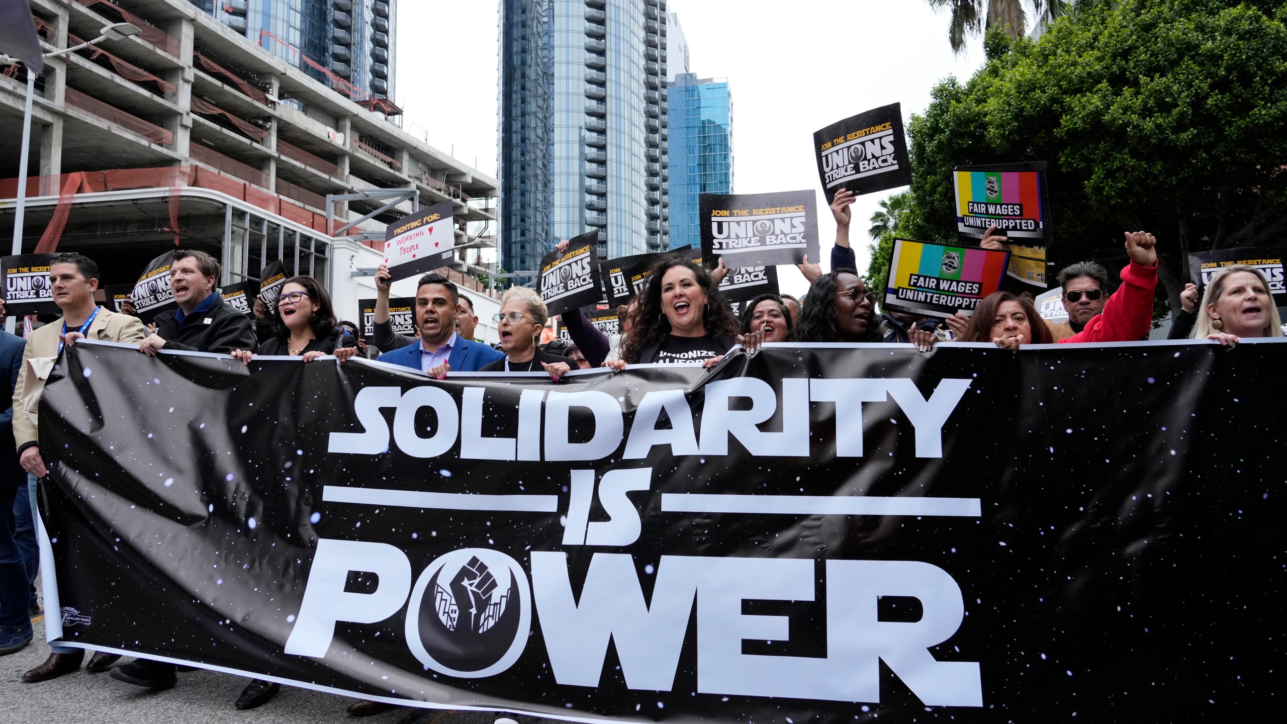 Union members march through downtown Los Angeles at the "Unions Strike Back" rally, Friday, May 26, 2023. Union members from the tourism and hospitality, Hollywood, public sector, education and logistics industries mobilized for a display of collective solidarity. (AP Photo/Chris Pizzello)