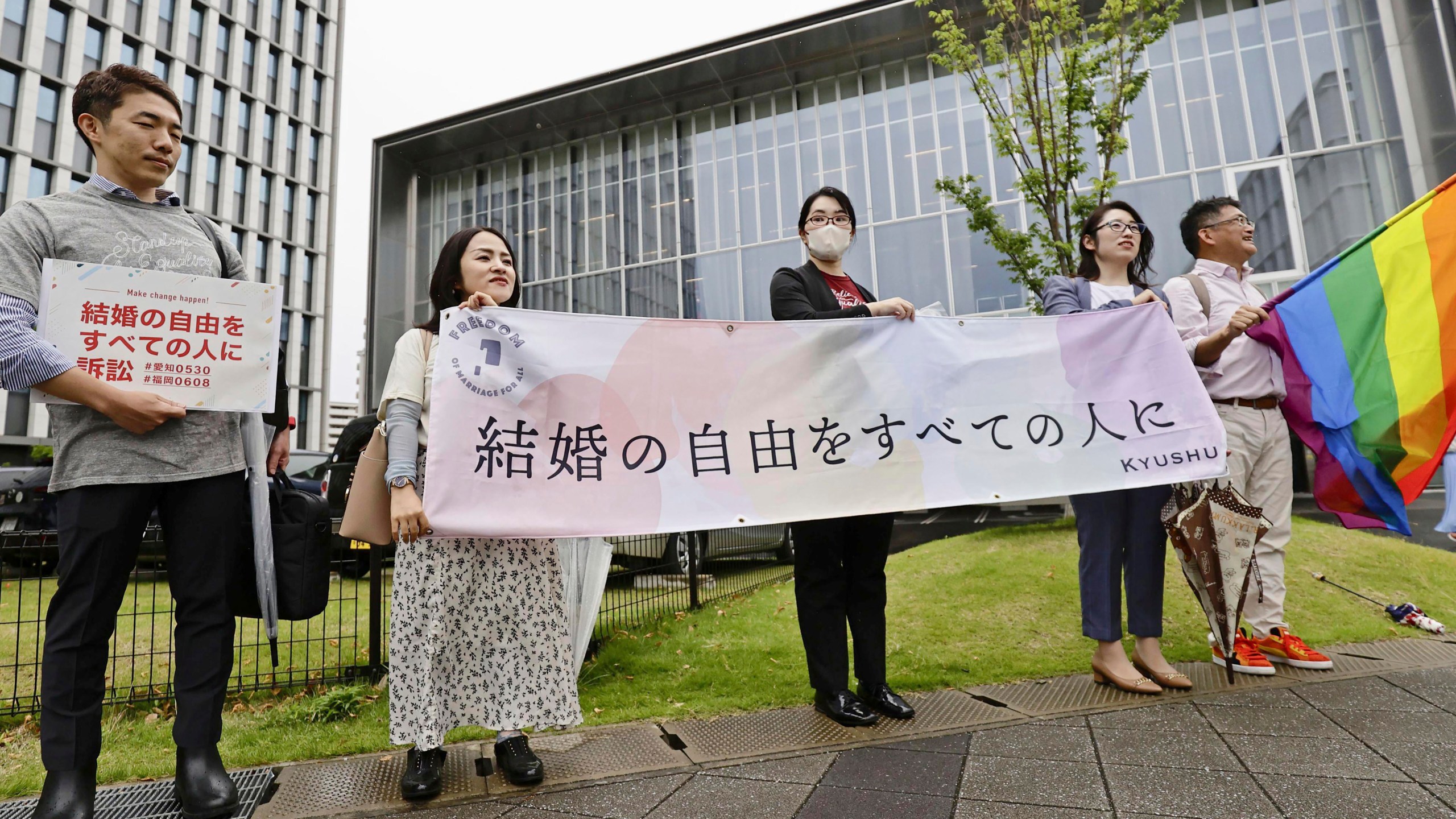 Lawyers unfurl a banner, which reads "Marriage freedom for all," before a ruling outside the Fukuoka District Court in Fukuoka, southern Japan Thursday, June 8, 2023. A Japanese court on Thursday ruled that the government’s denial of same-sex marriage is in “unconstitutional state,” a latest court decision in favor of the couples and their supporters seeking equal rights as the only member of Group of Seven with no legal protection for LGBTQ faces growing global attention.(Kyodo News via AP)