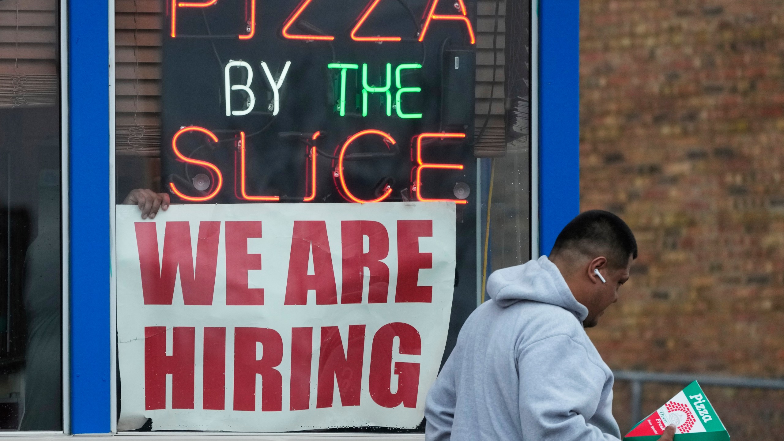 FILE - A hiring sign is displayed at a restaurant in Prospect Heights, Ill., on April 4, 2023. The hot jobs market has been defying a weakening economy and confounding the Federal Reserve for months, but now shows signs of cooling. The latest set of employment data from the government shows that job openings fell in March to their lowest level since April 2021. Layoffs rose to 1.8 million, their highest level since December 2020. (AP Photo/Nam Y. Huh, File)