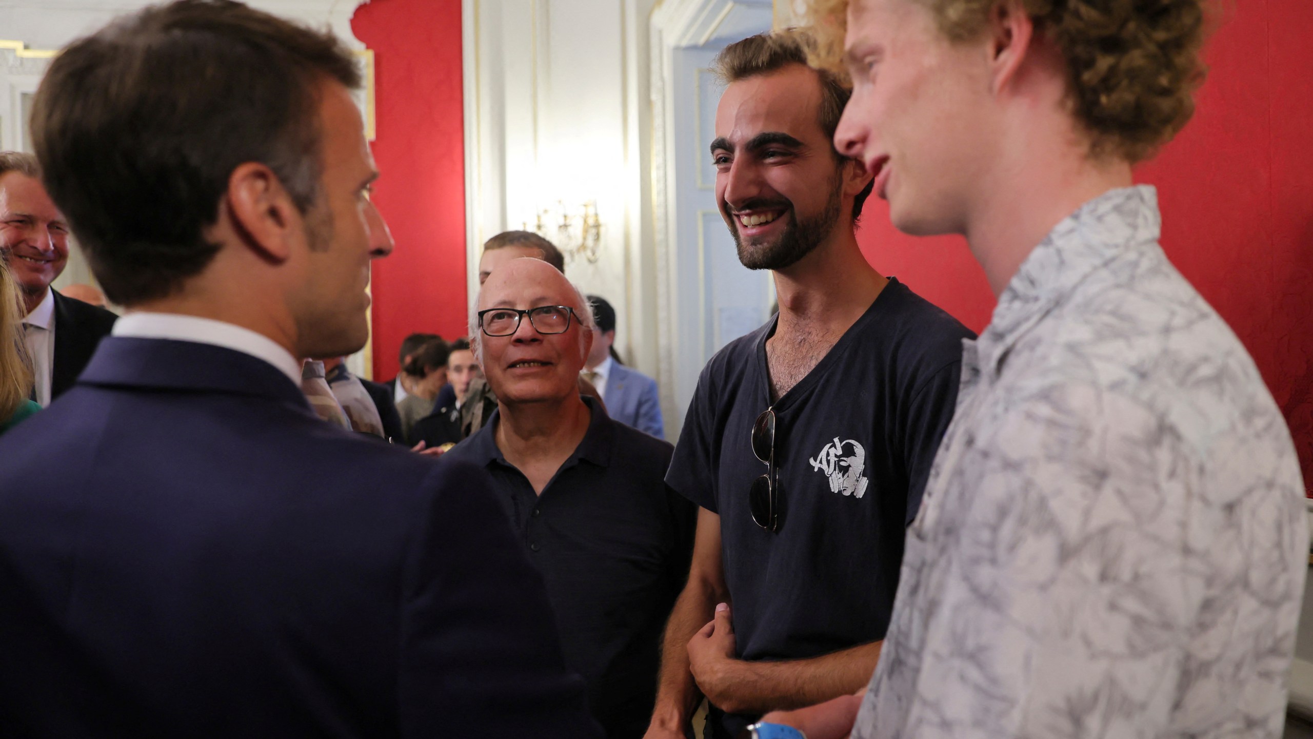 French President Emmanuel Macron meets Henri, second right, the 24-year-old 'backpack hero', his friend Lilian and Youssouf, who suffered minor stab wounds as he tried to intercept the suspect as he fled, in Annecy, French Alps, Friday, June 9, 2023. A man with a knife stabbed four young children at a lakeside park in the French Alps on Thursday June 8, 2023, assaulting at least one in a stroller repeatedly. Authorities said the children, between 22 months and 3 years old, suffered life-threatening injuries, and two adults were also wounded. (Denis Balibouse/Pool via AP)