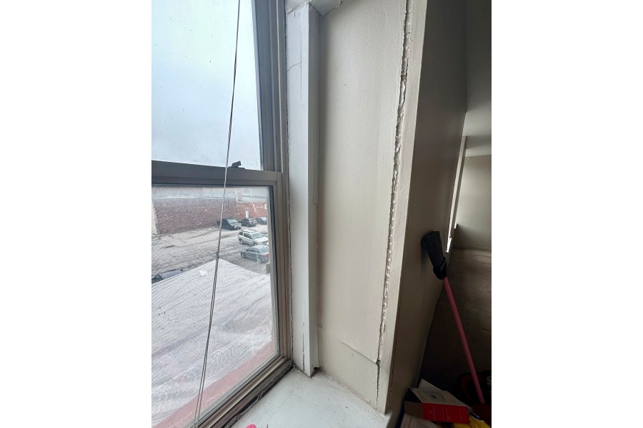 Cracks run along the window sill in an apartment rented by Shauna Dixon before a section of the 116-year-old Davenport apartment building later collapsed in May. The collapse left three dead, and about 50 homeless without their possessions. (Shauna Dixon via AP)