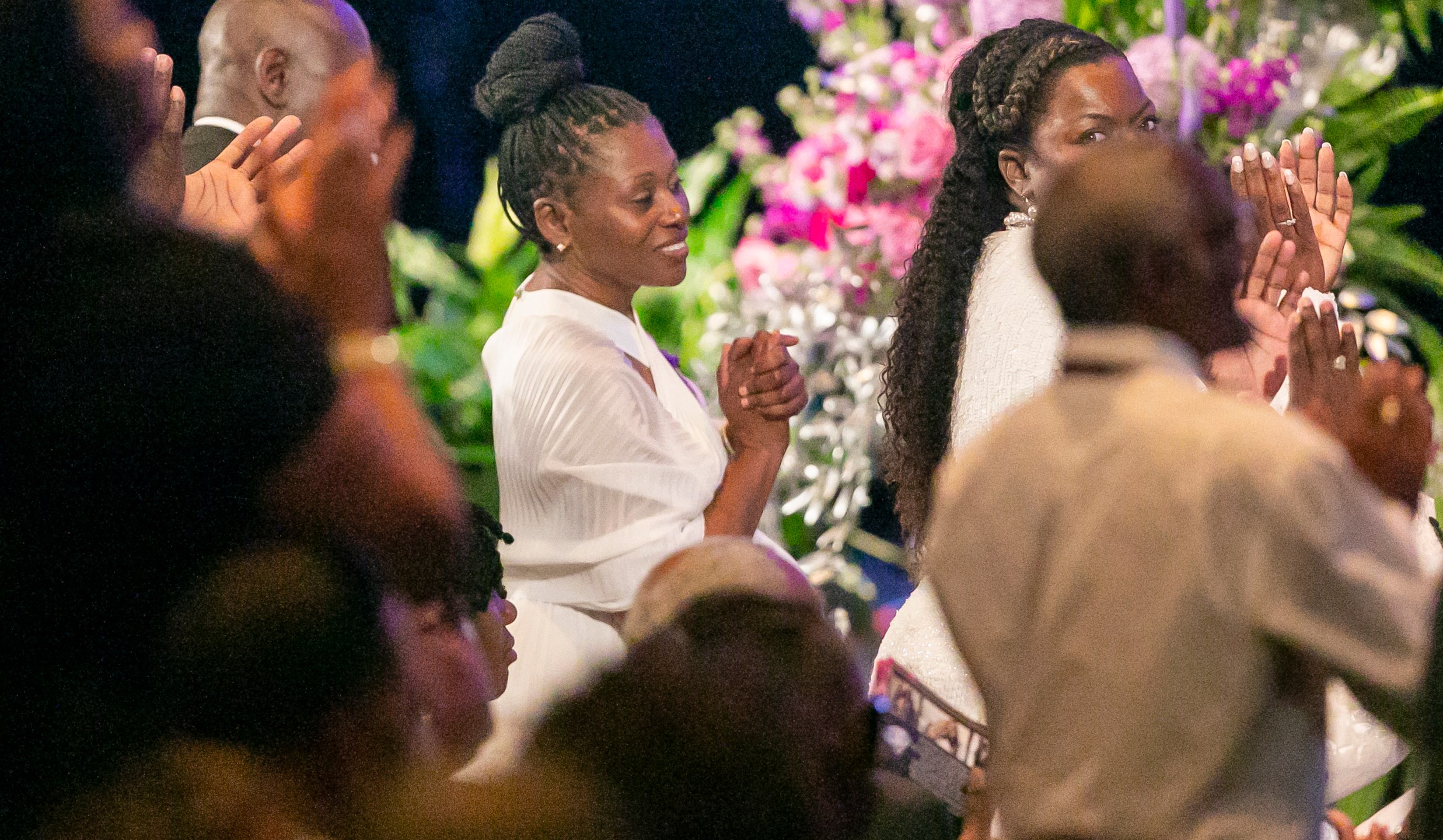 Pamela Dias, the mother of Ajike Owens, center, listens to the service during the funeral for Owens on Monday, June 12, 2023, at Meadowbrook Church in Ocala, Fla. Owens was fatally shot by her neighbor Susan Lorincz when she went to Lorincz's door. Lorincz was arrested and charged in the shooting. (AP Photo/ Alan Youngblood)