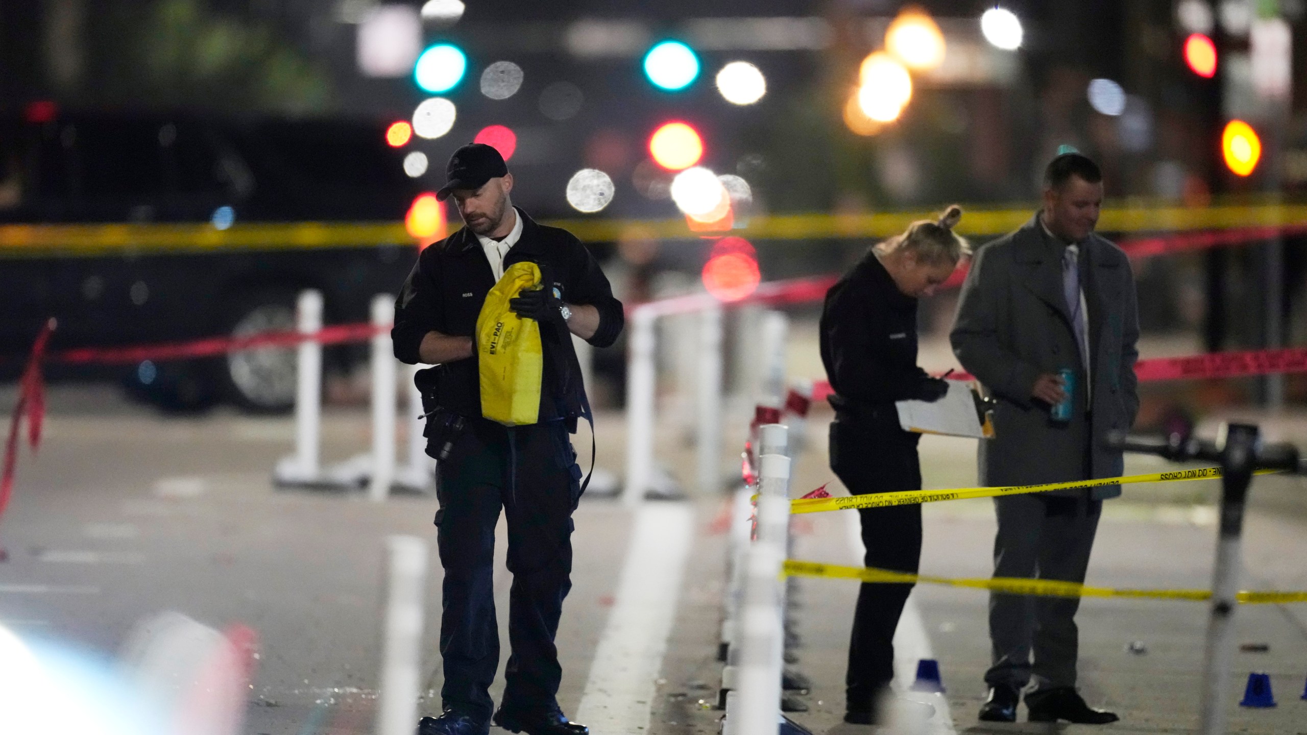 Denver Police Department investigators work the scene of a mass shooting along Market Street between 20th and 21st avenues during a celebration after the Denver Nuggets won the team's first NBA Championship early Tuesday, June 13, 2023, in Denver. (AP Photo/David Zalubowski)