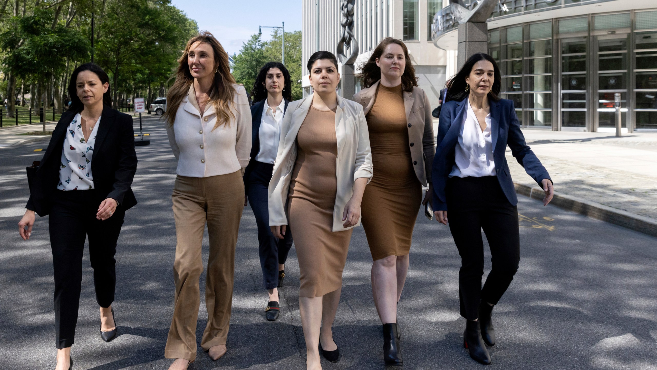 Nicole Daedone, second from left, founder and former CEO of OneTaste, second from left, departs Brooklyn federal court on Tuesday, June 13, 2023, in New York. Daedone, an entrepreneur who promoted group “orgasmic meditation” as a road to women’s well-being, turned herself in and pleaded not guilty Tuesday to a charge of manipulating traumatized people into debt, undesired sex and underpaid work. (AP Photo/Jeenah Moon)