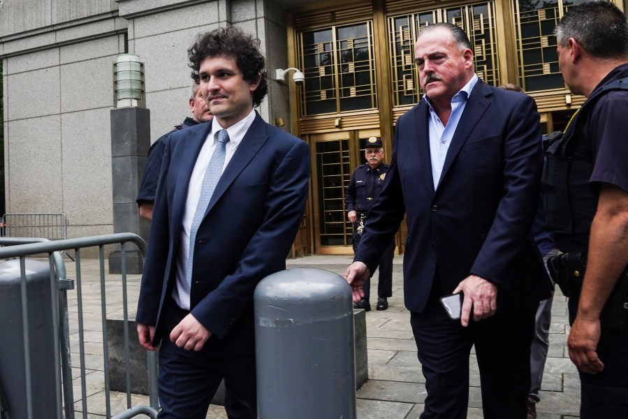 FTX founder Sam Bankman-Fried, left, leaves Manhattan federal court, Thursday June 15, 2023, in New York. Bankman-Fried's lawyers encountered a skeptical federal judge when they argued that he should toss out criminal fraud charges their client faces after the collapse of his cryptocurrency business. (AP Photo/Bebeto Matthews)