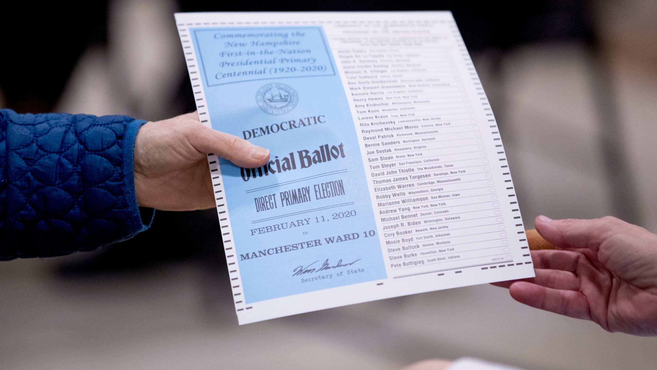 FILE - A woman takes a Democratic ballot to vote in the New Hampshire Primary at Parker-Varney Elementary School, Tuesday, Feb. 11, 2020, in Manchester, N.H. President Joe Biden's plan to overhaul his party's 2024 presidential primary schedule remained unsettled on Friday, June 16, 2023, after a Democratic rules committee gave New Hampshire more time to comply with new rules that leaders there fiercely oppose, but opted not to immediately offer such an extension to another battleground state, Georgia. (AP Photo/Andrew Harnik, File)