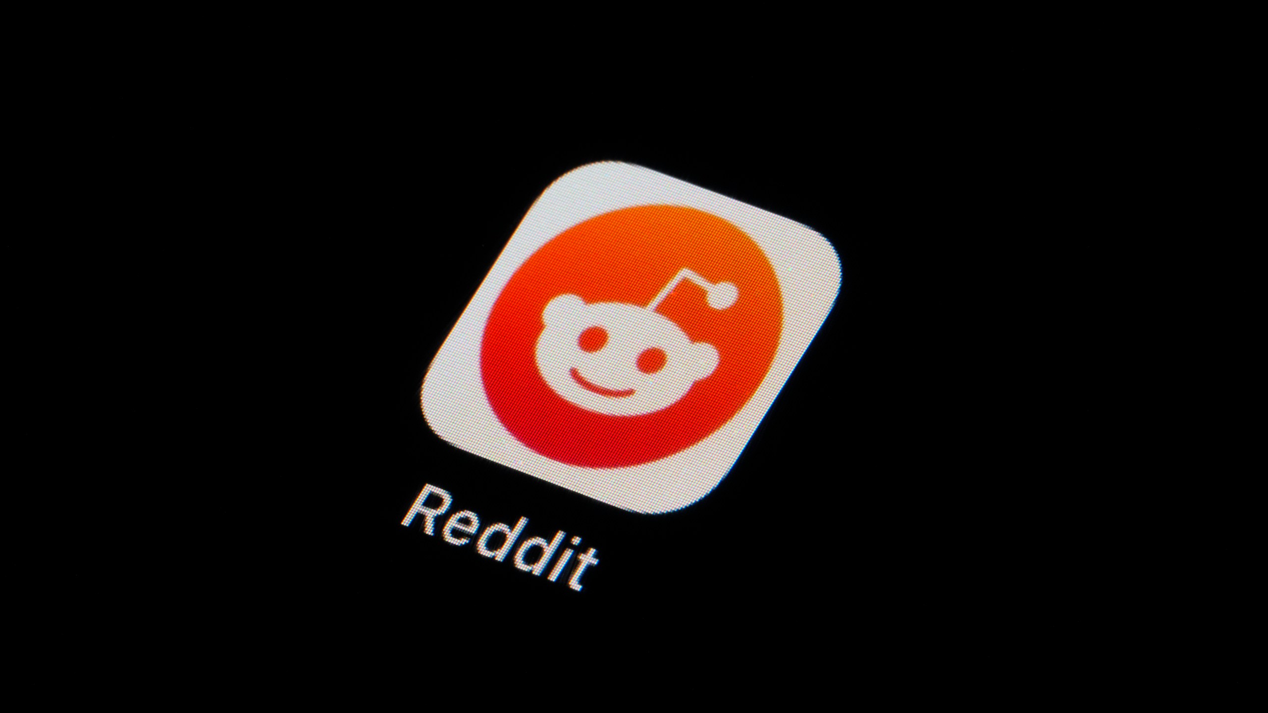 FILE - The Reddit app icon is seen on a smartphone on Feb. 28, 2023, in Marple Township, Pa. More than 8,000 subreddits, or Reddit communities, have gone dark as of Tuesday, June 13, in protest of upcoming API changes, which include a controversial policy that will charge some third-party apps for continued use. (AP Photo/Matt Slocum, File)