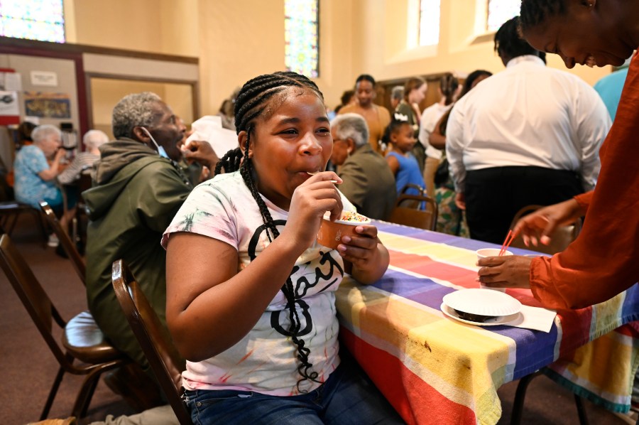 A'lelia Johnson, 12, of Detroit, enjoys ice cream during a social gathering after Mass concluded, Sunday, June 18, 2023, at Gesu Catholic Church in Detroit. (AP Photo/Jose Juarez)