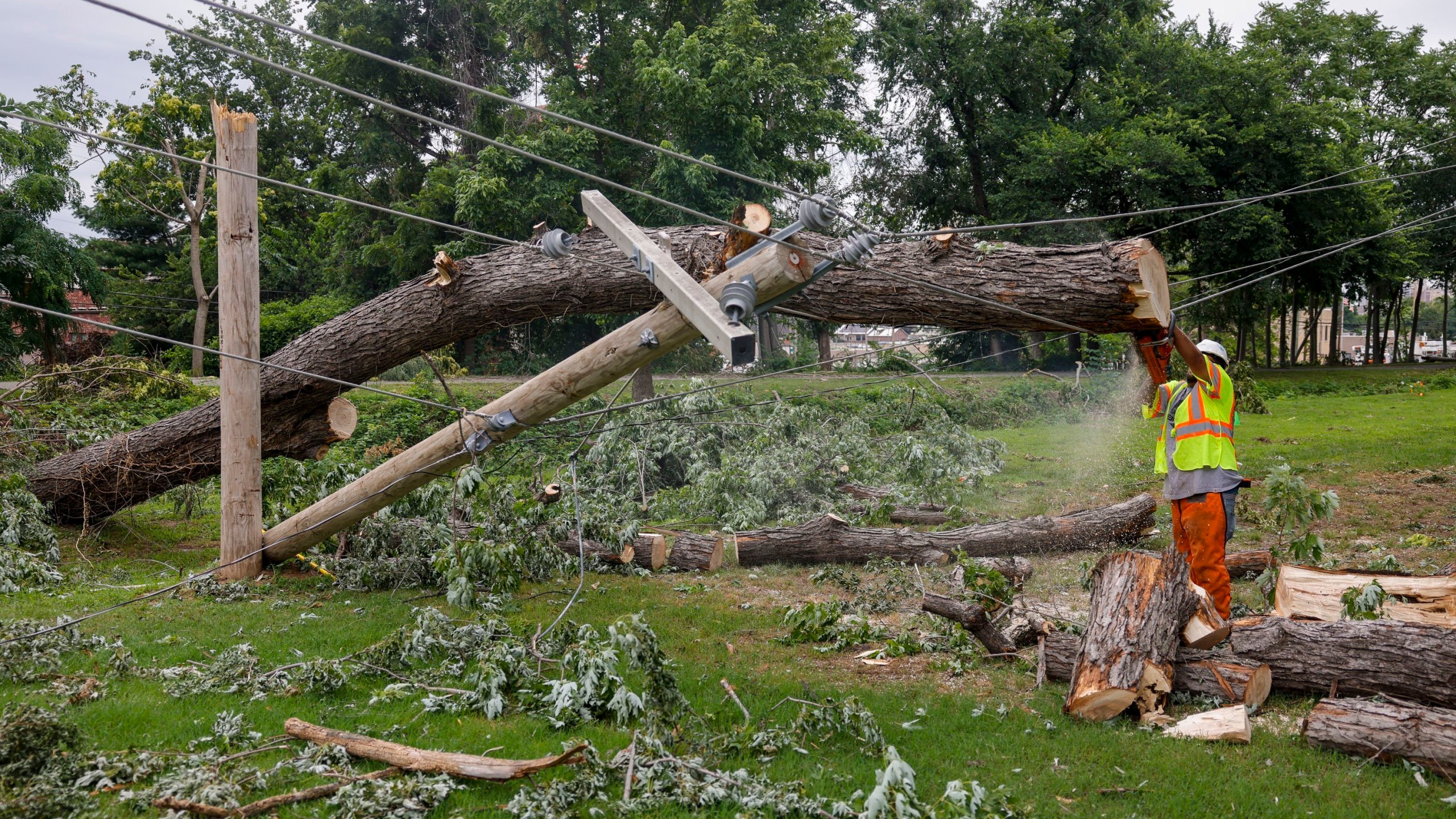 A utility crew works on downed utility lines near 21st Street and Boulder Ave. Tuesday, June 20, 2023 in Tulsa, Okla. Heavy storms last weekend down trees and power lines. (Mike Simons/Tulsa World via AP)