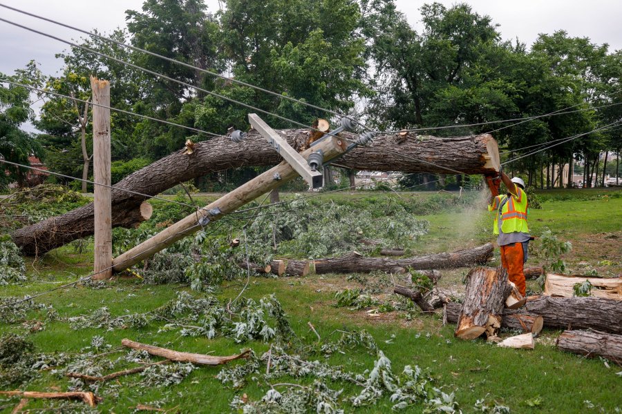 A utility crew works on downed utility lines near 21st Street and Boulder Ave. Tuesday, June 20, 2023 in Tulsa, Okla. Heavy storms last weekend down trees and power lines. (Mike Simons/Tulsa World via AP)