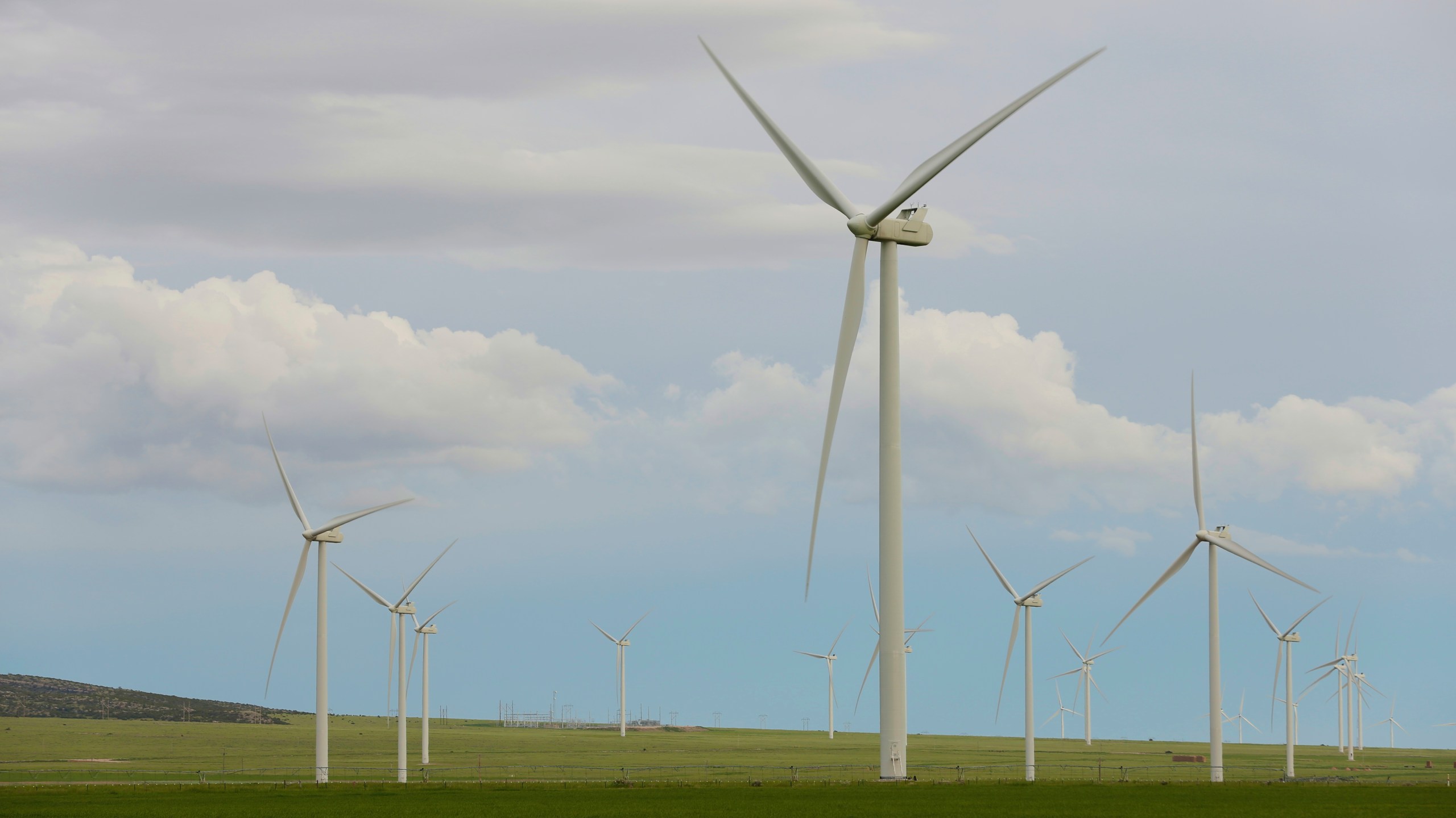 FILE - Wind turbines stand at a wind farm along the Montana-Wyoming state line on June 13, 2022. Wyoming and federal officials will formally kick off construction Tuesday, June 20, 2023, of a massive transmission line project to export wind power from Wyoming to southern California. But despite extensive wildlife studies, design tweaks and clearing of lengthy federal environmental reviews, the projects are now being built amid a more tepid attitude about wind power in Wyoming than when they were first proposed more than 15 years ago. (AP Photo/Emma H. Tobin, File)