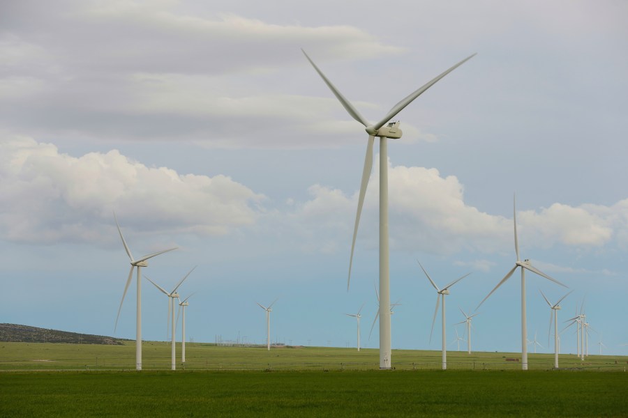 FILE - Wind turbines stand at a wind farm along the Montana-Wyoming state line on June 13, 2022. Wyoming and federal officials will formally kick off construction Tuesday, June 20, 2023, of a massive transmission line project to export wind power from Wyoming to southern California. But despite extensive wildlife studies, design tweaks and clearing of lengthy federal environmental reviews, the projects are now being built amid a more tepid attitude about wind power in Wyoming than when they were first proposed more than 15 years ago. (AP Photo/Emma H. Tobin, File)