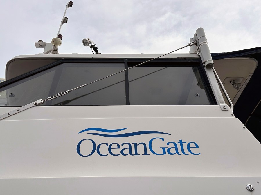 The logo for OceanGate Expeditions is seen on a boat parked near the offices of the company at a marine industrial warehouse office door in Everett, Wash., Tuesday, June 20, 2023. Rescuers raced against time to find the missing submersible carrying five people, who were reported overdue Sunday night. (AP Photo/Ed Komenda)