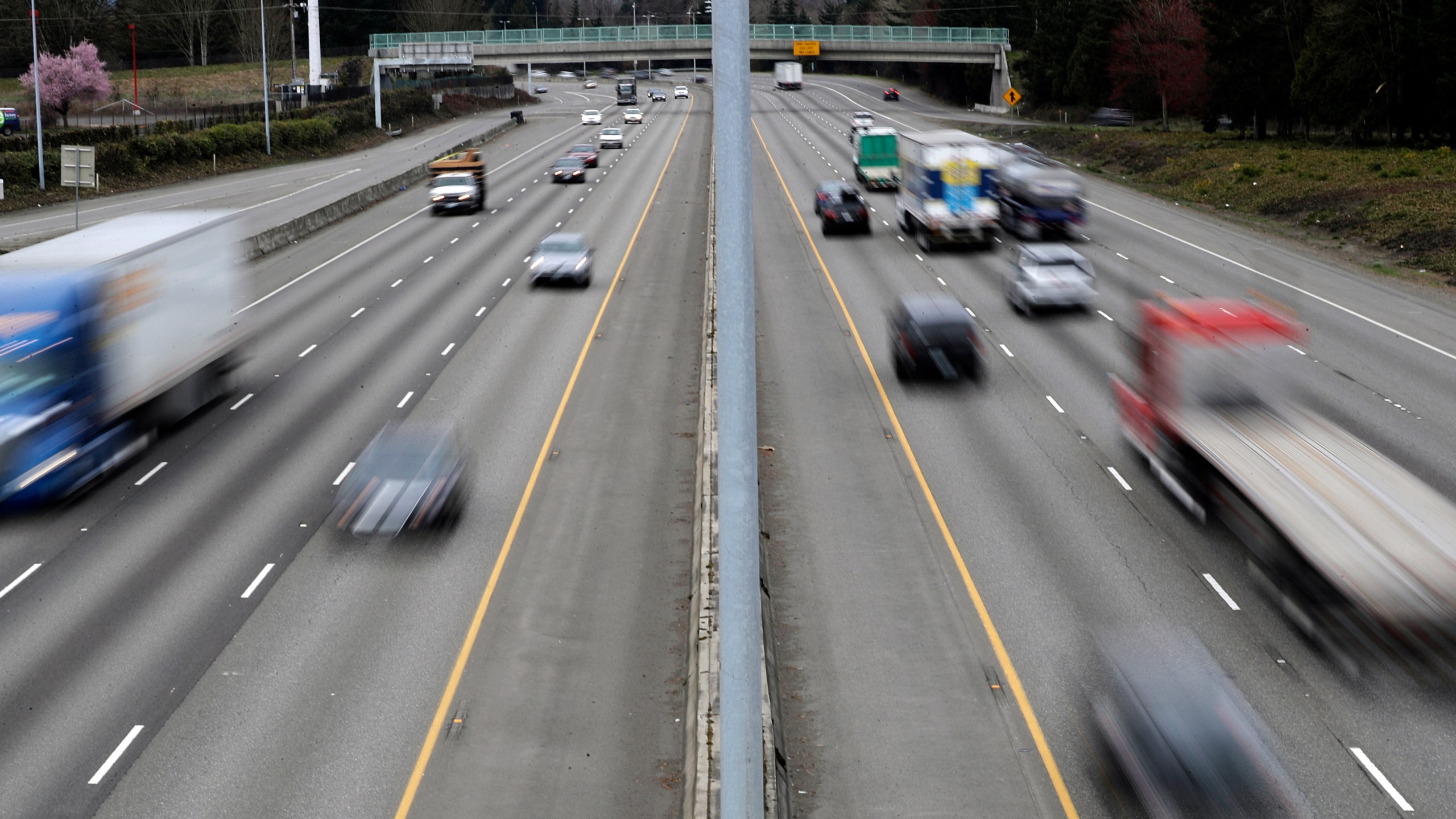 FILE - Cars and trucks travel on Interstate 5 near Olympia, Wash., March 25, 2019. The government’s traffic safety agency said Thursday, June 22, 2023, that it will require heavy trucks and buses to include potentially life-saving automatic emergency braking equipment within five years. Automatic braking systems in heavy vehicles would prevent nearly 20,000 crashes a year and save at least 155 lives, the National Highway Traffic Safety Administration said. (AP Photo/Ted S. Warren, File)