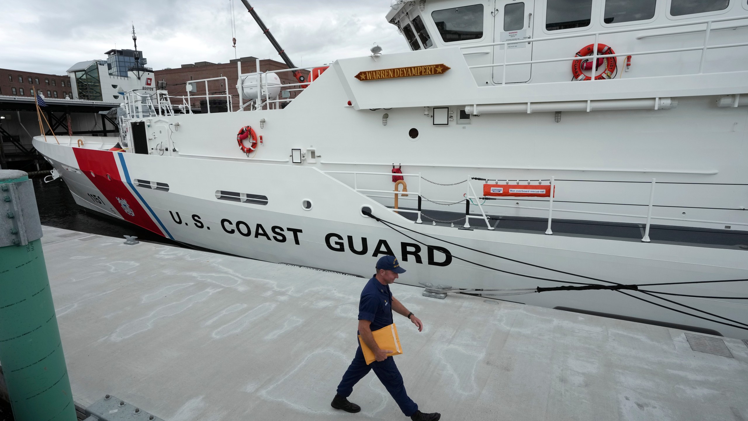 FILE - The U.S. Coast Guard Cutter Warren Deyampert is docked as a member of the Coast Guard walks past, Tuesday, June 20, 2023, at Coast Guard Base Boston, in Boston. (AP Photo/Steven Senne, File)