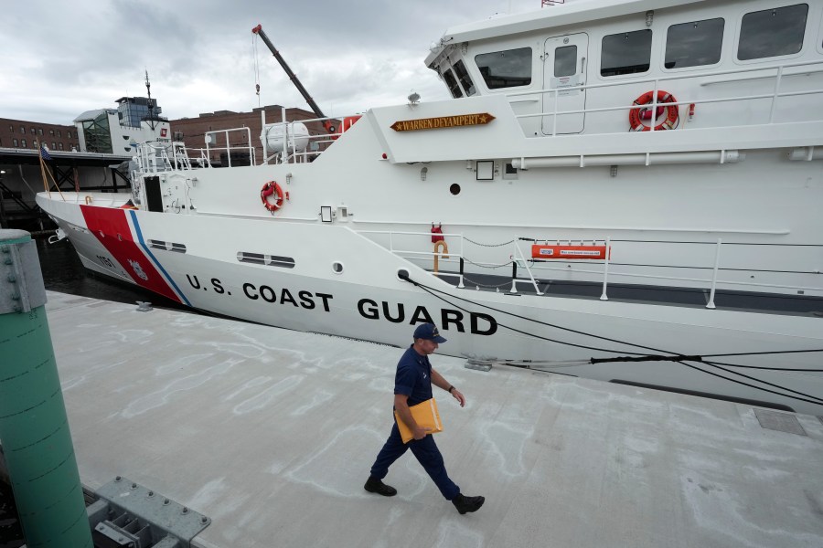 FILE - The U.S. Coast Guard Cutter Warren Deyampert is docked as a member of the Coast Guard walks past, Tuesday, June 20, 2023, at Coast Guard Base Boston, in Boston. (AP Photo/Steven Senne, File)