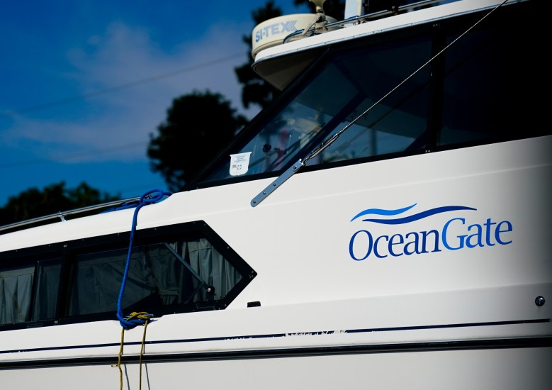 A boat with the OceanGate logo is parked on a lot near the OceanGate offices Thursday, June 22, 2023, in Everett, Wash. The U.S. Coast Guard said Thursday that the missing submersible Titan imploded near the Titanic shipwreck site, killing everyone on board. (AP Photo/Lindsey Wasson)