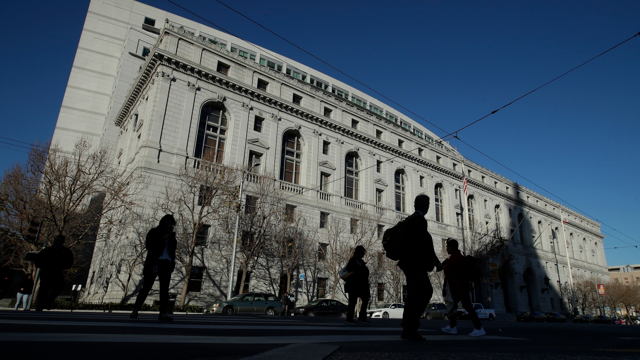 FILE - People walk past The Earl Warren Building, headquarters of the Supreme Court of California, on Jan. 7, 2020 in San Francisco. On Thursday, June 22, 2023, the Supreme Court of California ruled that police are not immune from civil lawsuits for misconduct that happens during investigations. (AP Photo/Jeff Chiu, File)