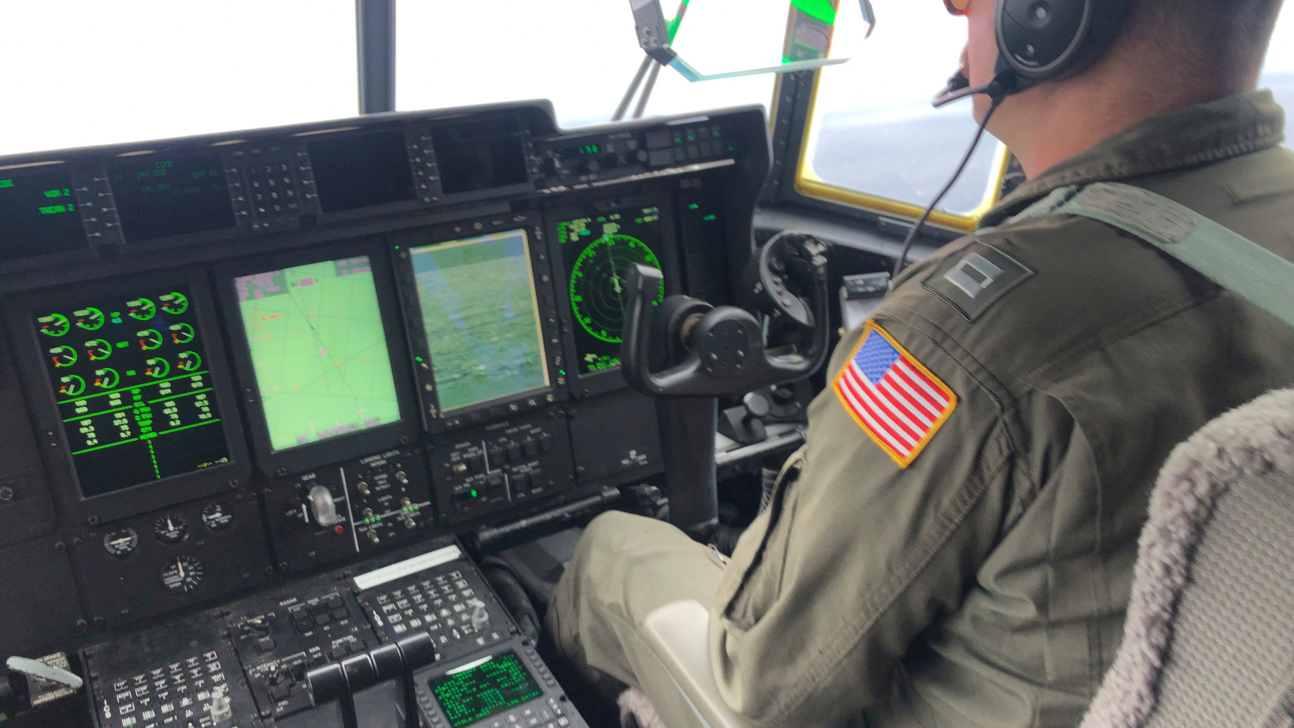 In this image provided by the U.S. Coast Guard, a crew member sits aboard a Coast Guard HC-130 Hercules airplane based at Coast Guard Air Station Elizabeth City, N.C., as it flies about 900 miles East of Cape Cod, Mass., during the search for the 21-foot submersible, Titan, Wednesday, June 21, 2023. (Petty Officer 1st Class Amber Howie/U.S. Coast Guard via AP)