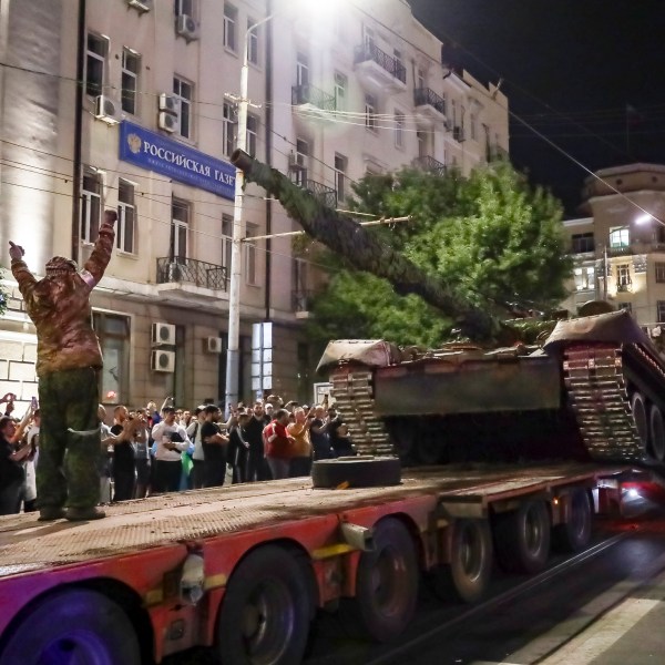 Members of the Wagner Group military company load their tank onto a truck on a street in Rostov-on-Don, Russia, Saturday, June 24, 2023, prior to leaving an area at the headquarters of the Southern Military District. Kremlin spokesman Dmitry Peskov said that Yevgeny Prigozhin's troops who joined him in the uprising will not face prosecution and those who did not will be offered contracts by the Defense Ministry. After the deal was reached Saturday, Prigozhin ordered his troops to halt their march on Moscow and retreat to field camps in Ukraine, where they have been fighting alongside Russian troops. (AP Photo)