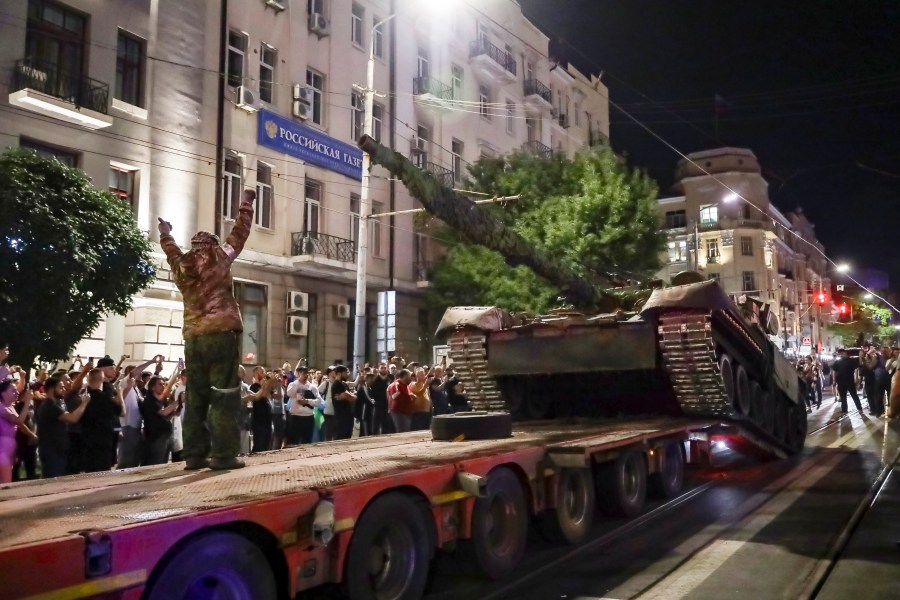 Members of the Wagner Group military company load their tank onto a truck on a street in Rostov-on-Don, Russia, Saturday, June 24, 2023, prior to leaving an area at the headquarters of the Southern Military District. Kremlin spokesman Dmitry Peskov said that Yevgeny Prigozhin's troops who joined him in the uprising will not face prosecution and those who did not will be offered contracts by the Defense Ministry. After the deal was reached Saturday, Prigozhin ordered his troops to halt their march on Moscow and retreat to field camps in Ukraine, where they have been fighting alongside Russian troops. (AP Photo)