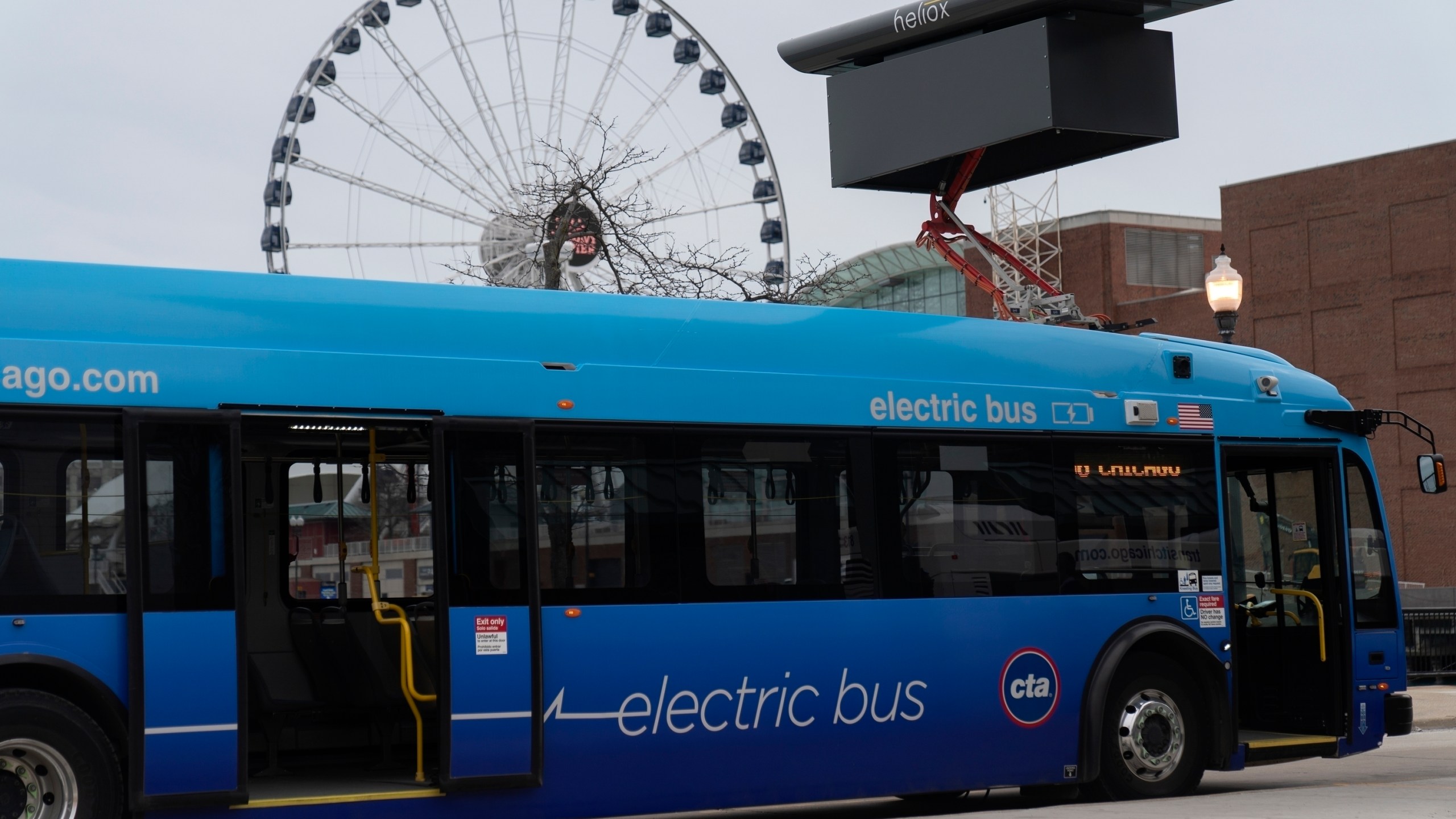 FILE - A Chicago Transit Authority electric bus charges at Navy Pier Tuesday, Feb. 14, 2023, in Chicago. The Transportation Department is awarding almost $1.7 billion in grants for buying zero and low emission buses, with the money going to transit projects in 46 states and territories. The grants will enable transit agencies and state and local governments to buy 1,700 U.S.-built buses, nearly half of which will have zero carbon emissions. (AP Photo/Erin Hooley, File)