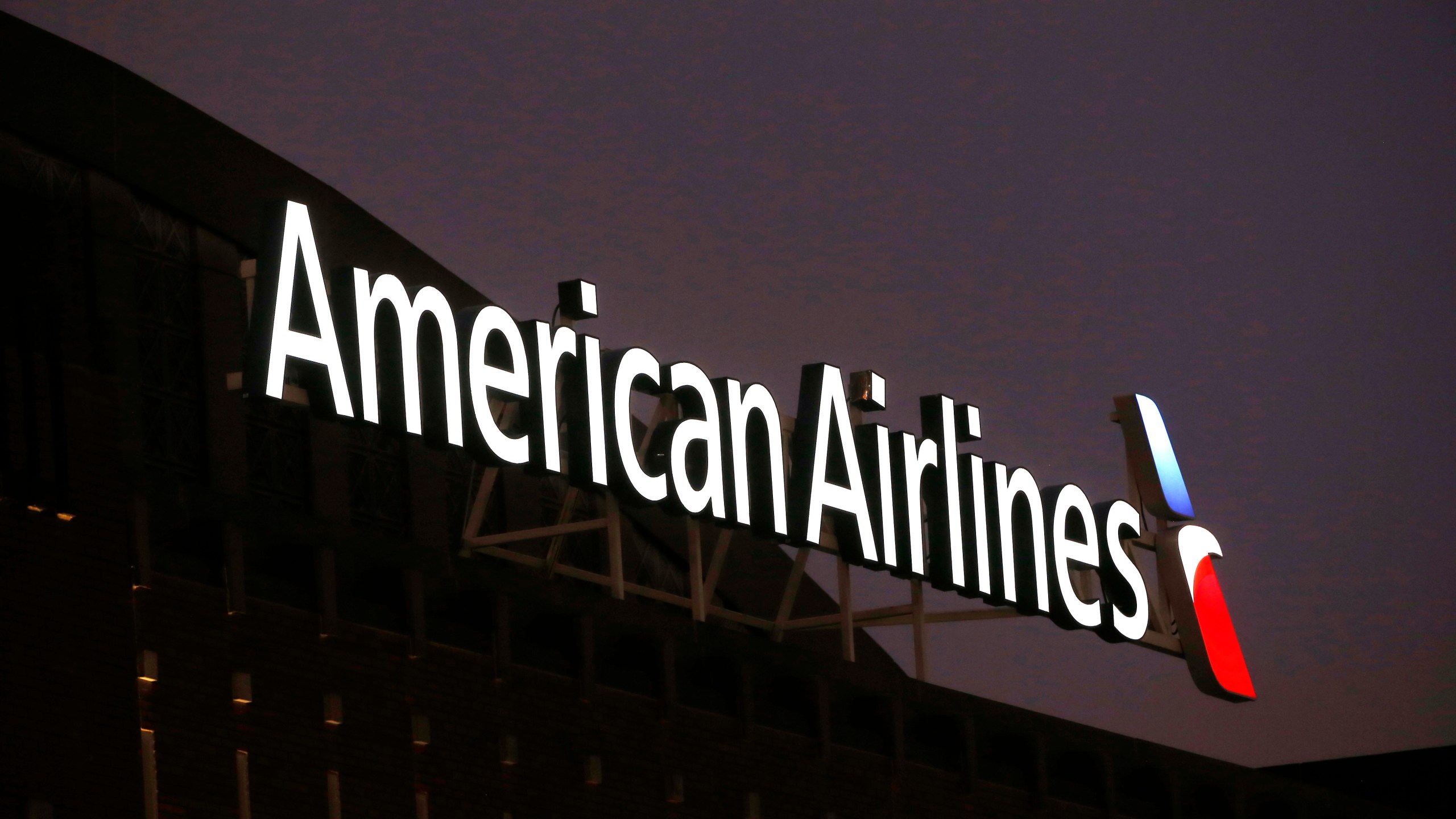 FILE - The American Airlines logo on top of the American Airlines Center in Dallas, Texas, Dec. 19, 2017. Personal information for more than 8,000 applicants to become pilots at American Airlines and Southwest Airlines was stolen when hackers broke into a data base maintained by a recruiting company. The breach at Austin, Texas-based Pilot Credentials occurred on April 30, and the airlines learned about it on May 3. (AP Photo/Michael Ainsworth, File)