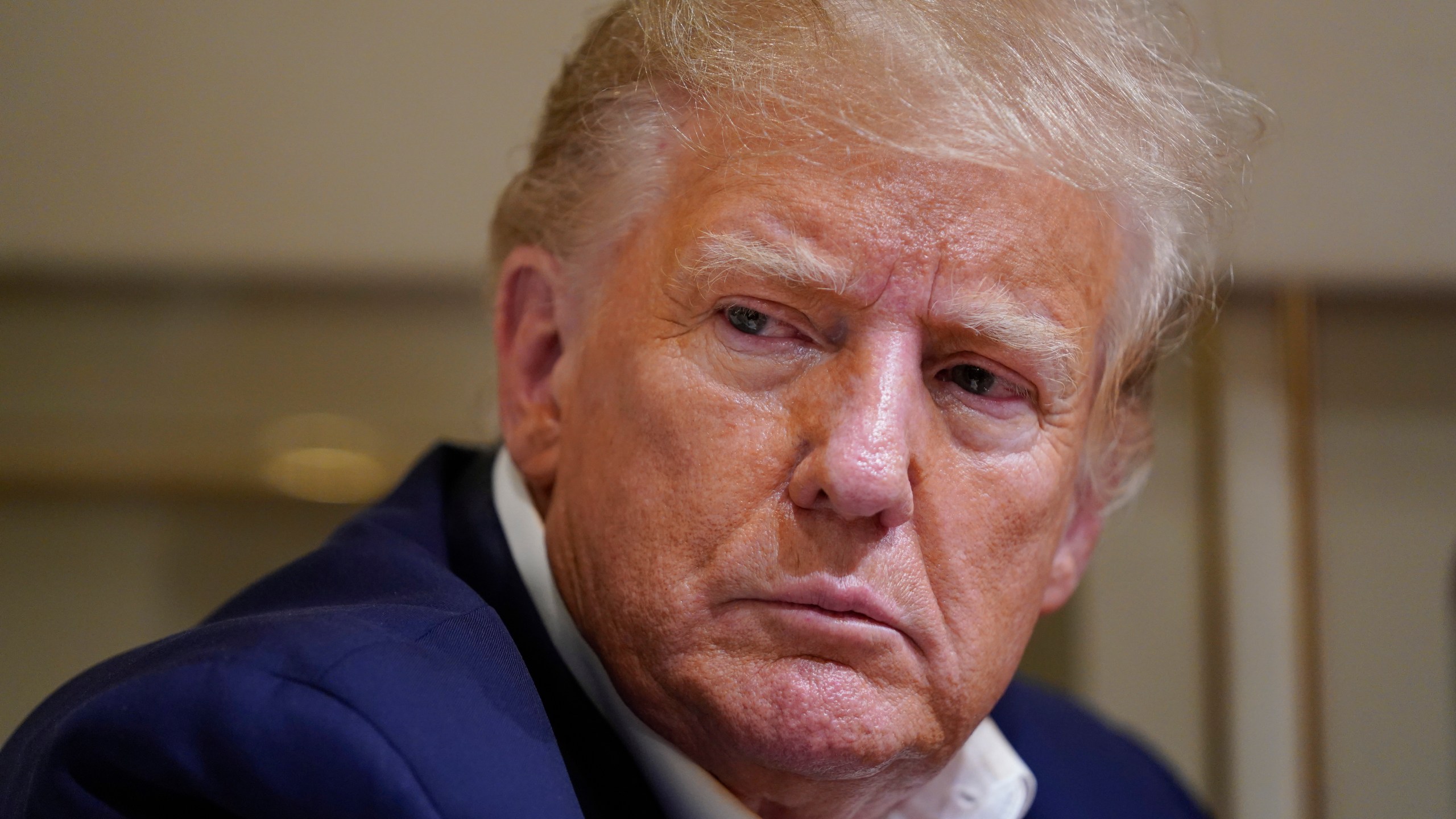 FILE - Former President Donald Trump listens as he speaks with reporters while in flight on his plane after a campaign rally at Waco Regional Airport, in Waco, Texas, on March 25, 2023, while en route to West Palm Beach, Fla. An audio recording that includes new details from a 2021 meeting in Bedminster, New Jersey, where former President Donald Trump discusses holding secret documents he did not declassify has been released. (AP Photo/Evan Vucci, File)