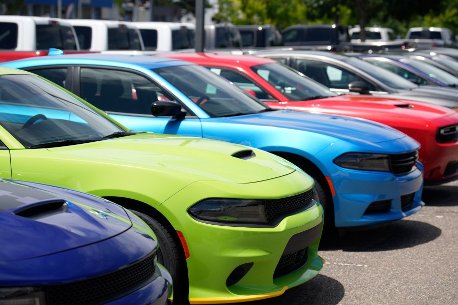 Unsold 2023 Charger sedans and Challenger hardtops sit in a long row at a Dodge dealership Sunday, June 18, 2023, in Littleton, Colo. On Tuesday, the Conference Board reports on U.S. consumer confidence for June. (AP Photo/David Zalubowski)