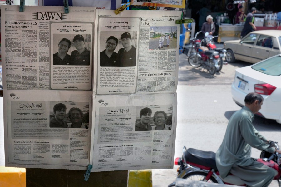 Morning newspapers publish an ad of condolence massages for two victims of Titan submersible incident, Shahzada Dawood and his son Suleman Dawood, by their family and firm, displayed at a roadside stall, in Islamabad, Pakistan, Tuesday, June 27, 2023. As an international group of agencies investigates why the Titan submersible imploded while carrying five people to the Titanic wreckage, U.S. maritime officials say they'll issue a report aimed at improving the safety of submersibles worldwide. (AP Photo/Anjum Naveed)