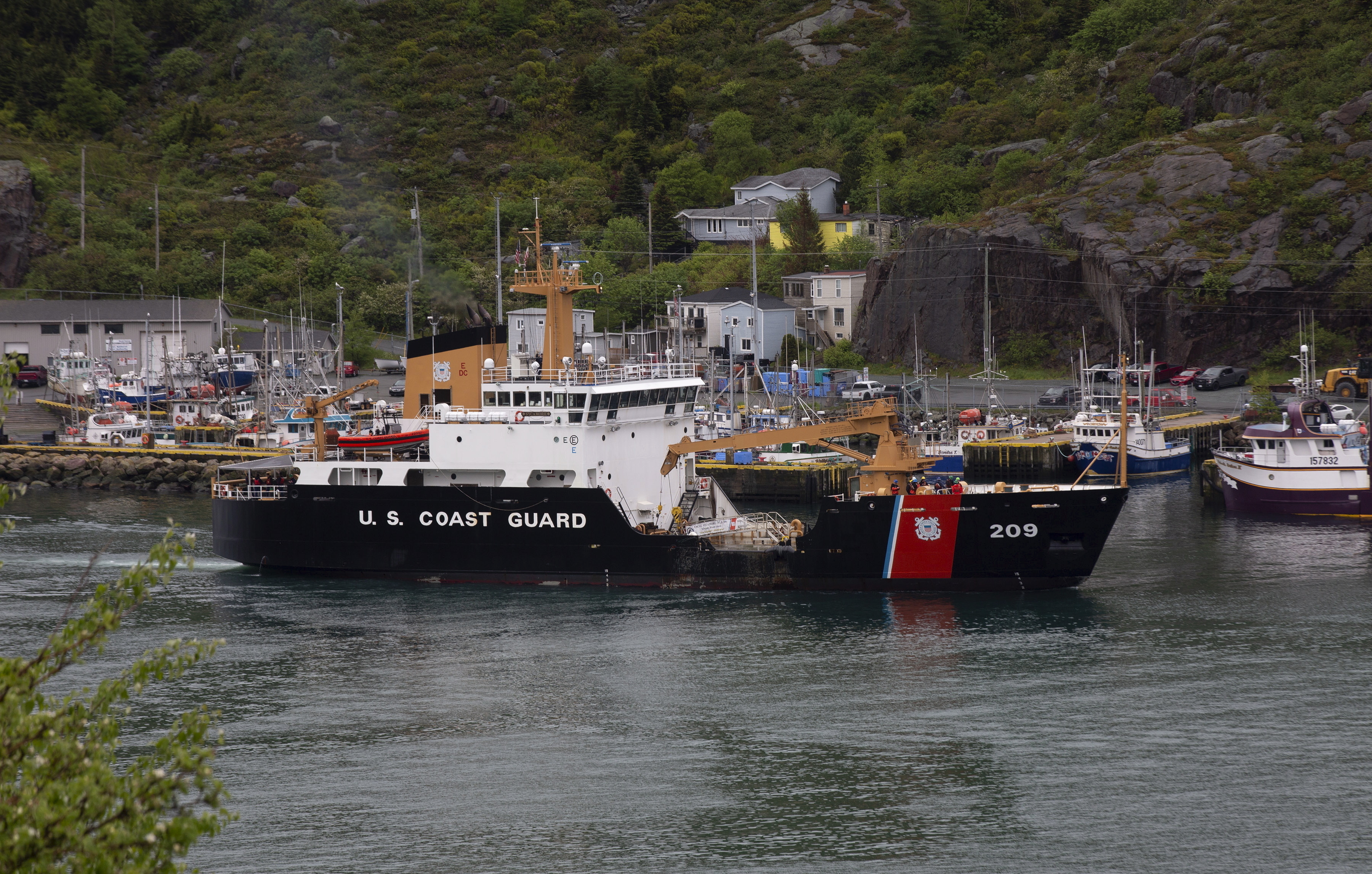 A U.S. Coast Guard ship arrives in the harbor of St. John's, Newfoundland, on Wednesday, June 28, 2023, following the arrival of the ship Horizon Arctic carrying debris from the Titan submersible. The submersible owned by OceanGate Expeditions imploded on its way to the wreck of the Titanic. (Paul Daly/The Canadian Press via AP)