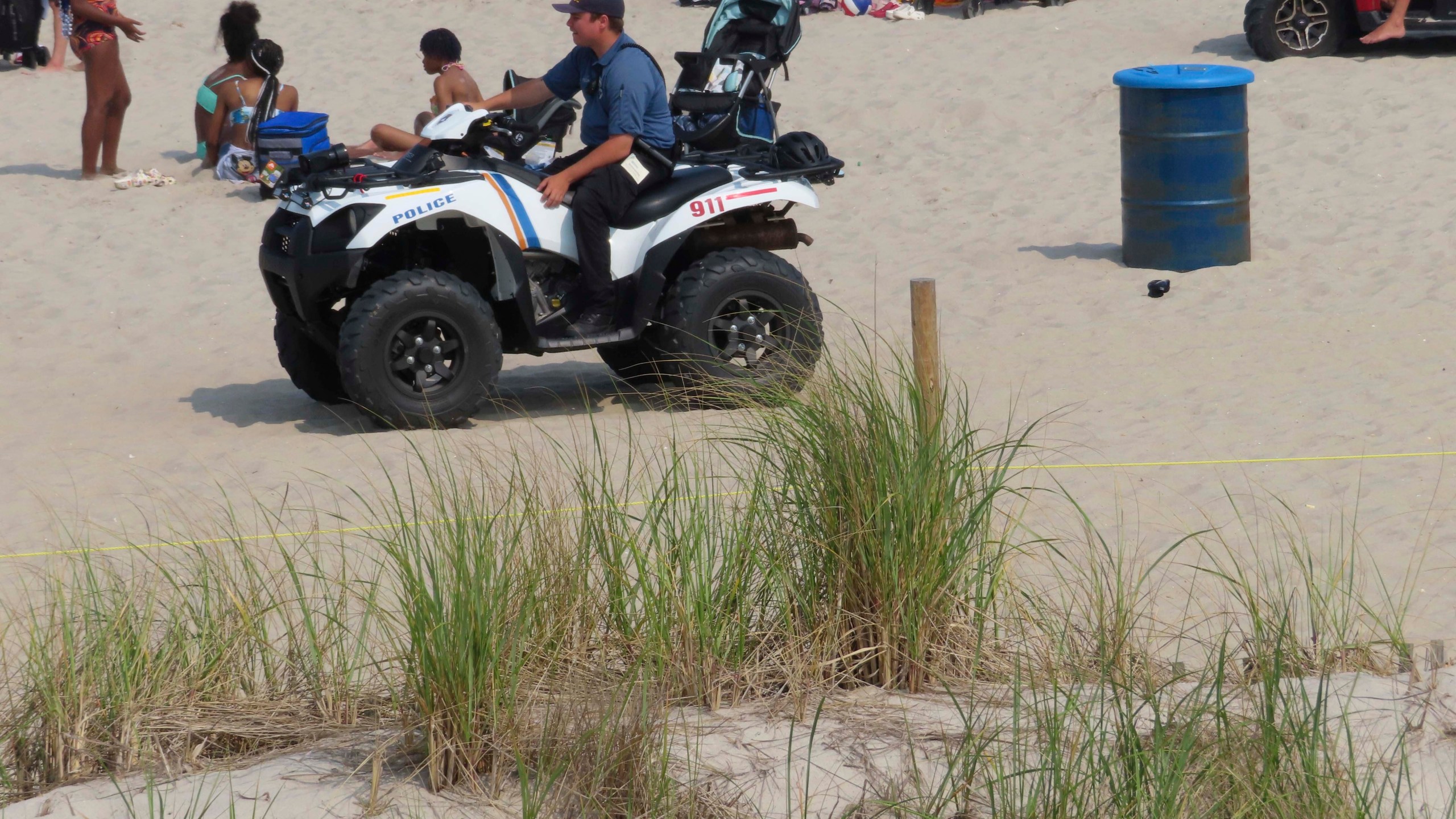 A police officer in a dune vehicle patrols the beach in Seaside Heights, N.J., on Thursday, June 29, 2023. Officials and residents of several New Jersey shore towns say the state’s law decriminalizing marijuana use is having an unintended effect: emboldening large groups of teenagers to run amok on beaches and boardwalks, knowing there is little chance of them getting in trouble for it. (AP Photo/Wayne Parry)