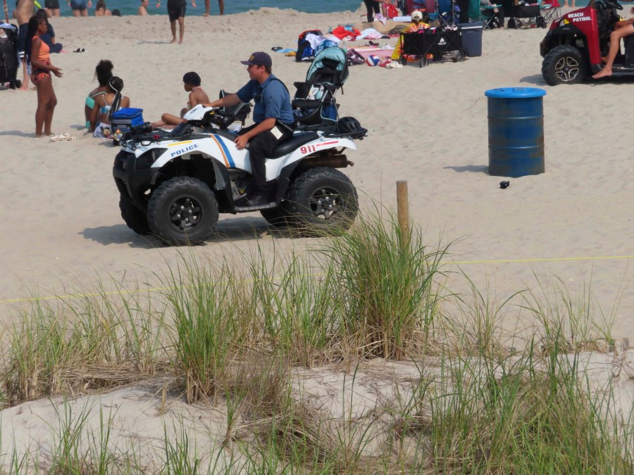 A police officer in a dune vehicle patrols the beach in Seaside Heights, N.J., on Thursday, June 29, 2023. Officials and residents of several New Jersey shore towns say the state’s law decriminalizing marijuana use is having an unintended effect: emboldening large groups of teenagers to run amok on beaches and boardwalks, knowing there is little chance of them getting in trouble for it. (AP Photo/Wayne Parry)