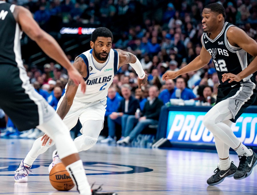 FILE - Dallas Mavericks guard Kyrie Irving (2) drives past San Antonio Spurs guard Malaki Branham (22) in the second half of an NBA basketball game Feb. 23, 2023, in Dallas. Irving agreed to stay with the Mavericks on a three-year, $126 million deal when free agency opened Friday, June 30, 2023. (AP Photo/Emil T. Lippe, File)