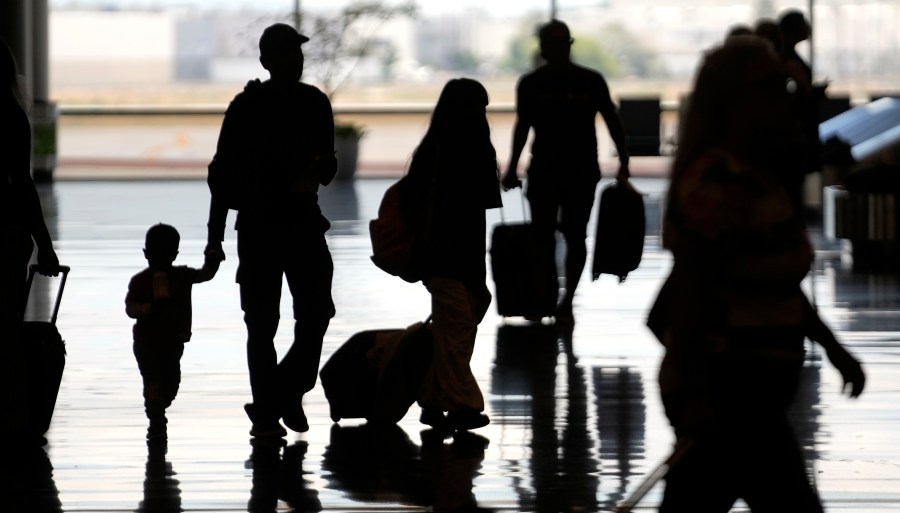 People travel through Salt Lake City International Airport Friday, June 30, 2023, in Salt Lake City. (AP Photo/Rick Bowmer)