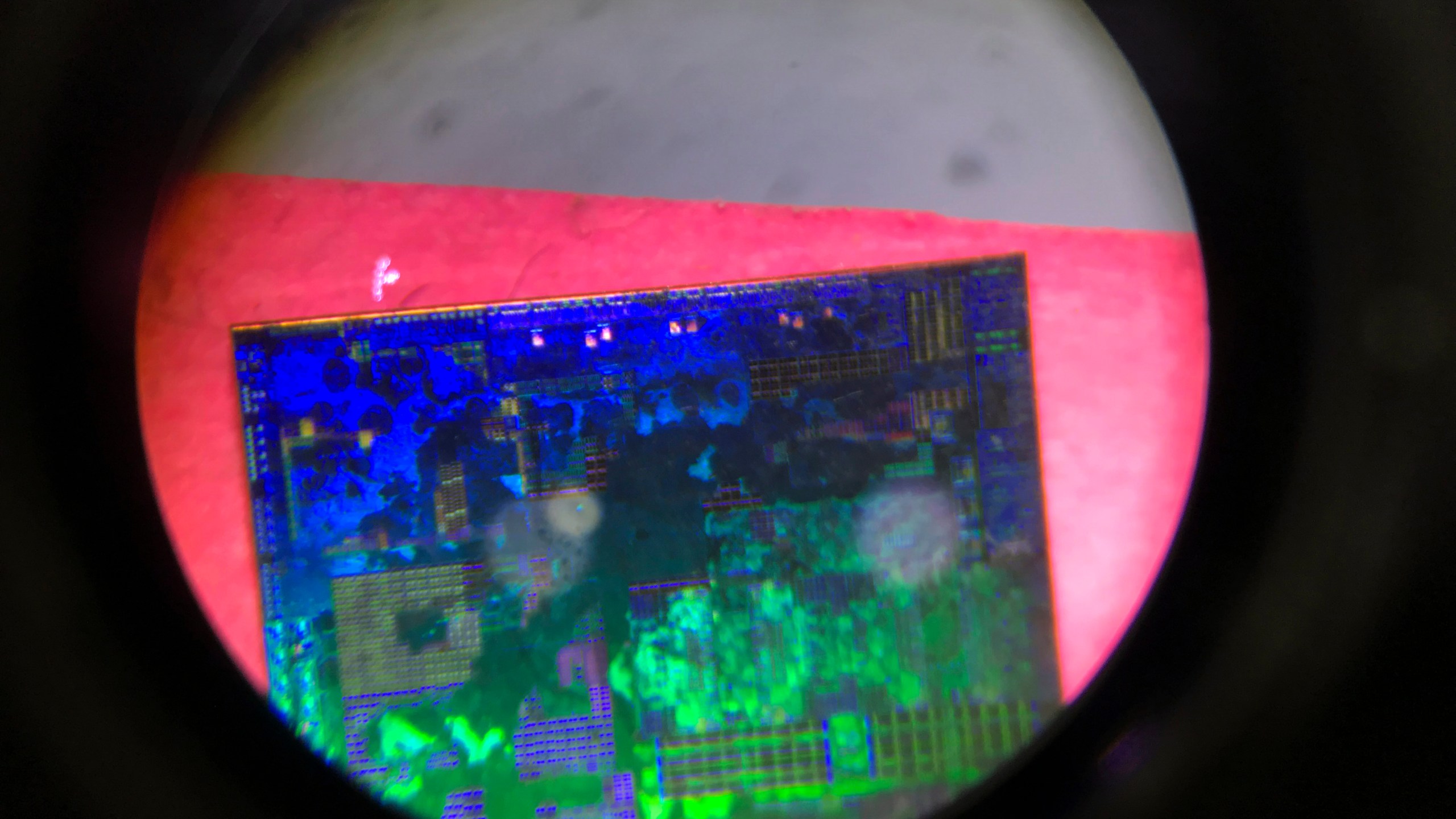 FILE - A Chinese microchip is seen through a microscope set up at the booth for the state-controlled Tsinghua Unigroup project which is aimed at driving China's semiconductor ambitions during the 21st China Beijing International High-tech Expo in Beijing, China, on May 17, 2018. China has imposed export curbs on two metals used in computer chips and solar cells, expanding a squabble with Washington over high-tech trade ahead of Treasury Secretary Janet Yellen's visit to Beijing this week. (AP Photo/Ng Han Guan, File)