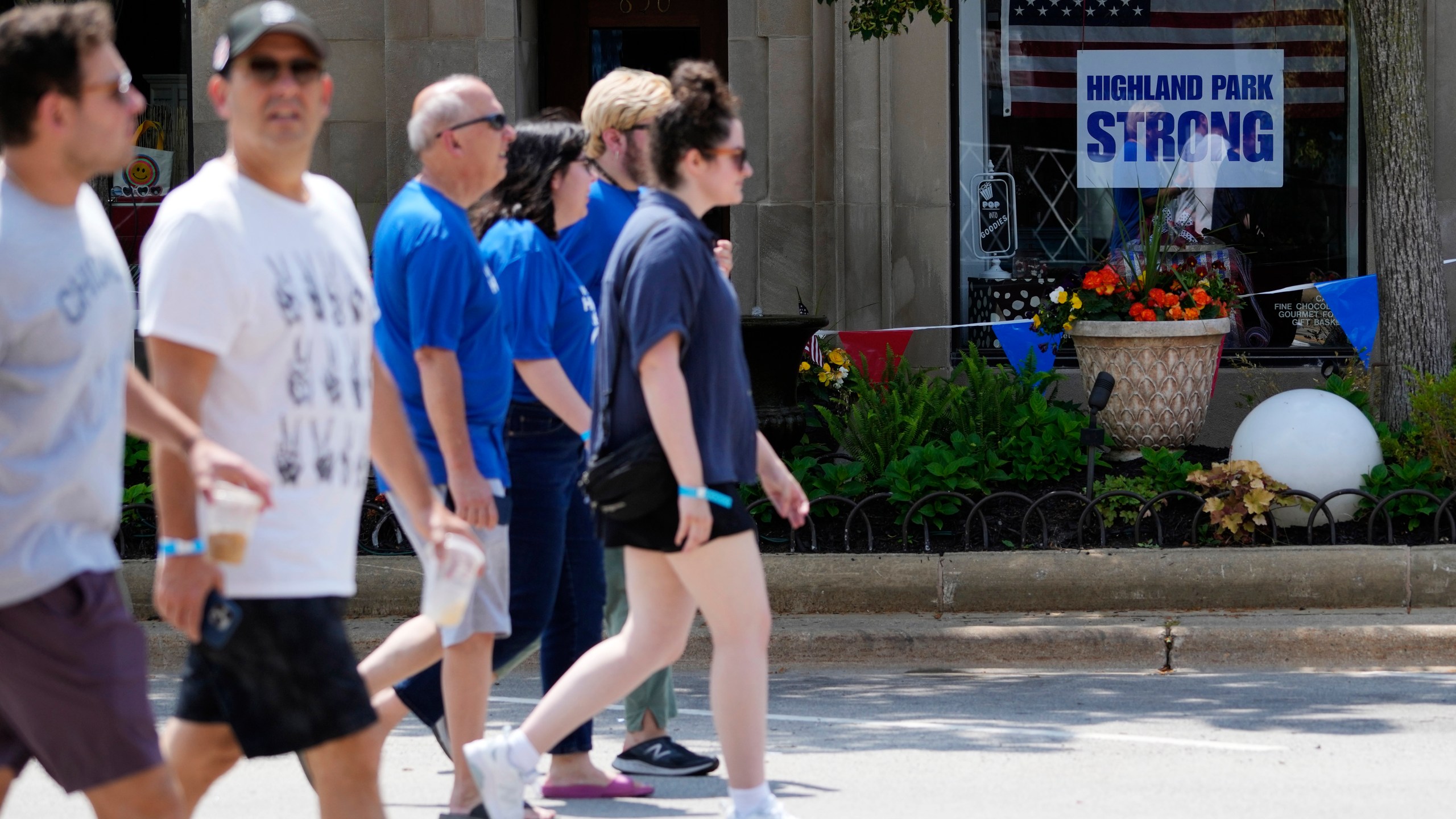 People participate in a community walk in Highland Park, Ill., Tuesday, July 4, 2023. One year after a shooter took seven lives at the city's annual parade, community members are planning to honor the victims and reclaim the space to move forward. (AP Photo/Nam Y. Huh)