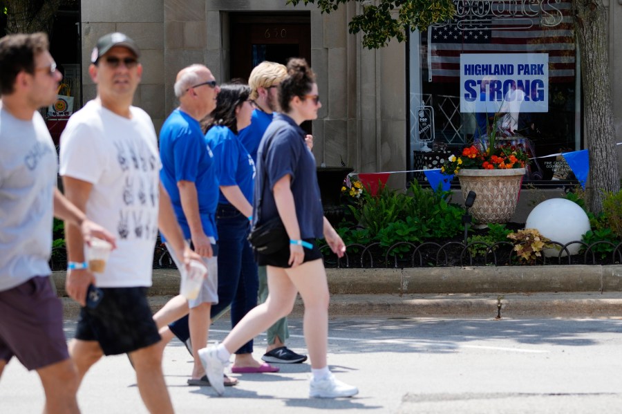 People participate in a community walk in Highland Park, Ill., Tuesday, July 4, 2023. One year after a shooter took seven lives at the city's annual parade, community members are planning to honor the victims and reclaim the space to move forward. (AP Photo/Nam Y. Huh)