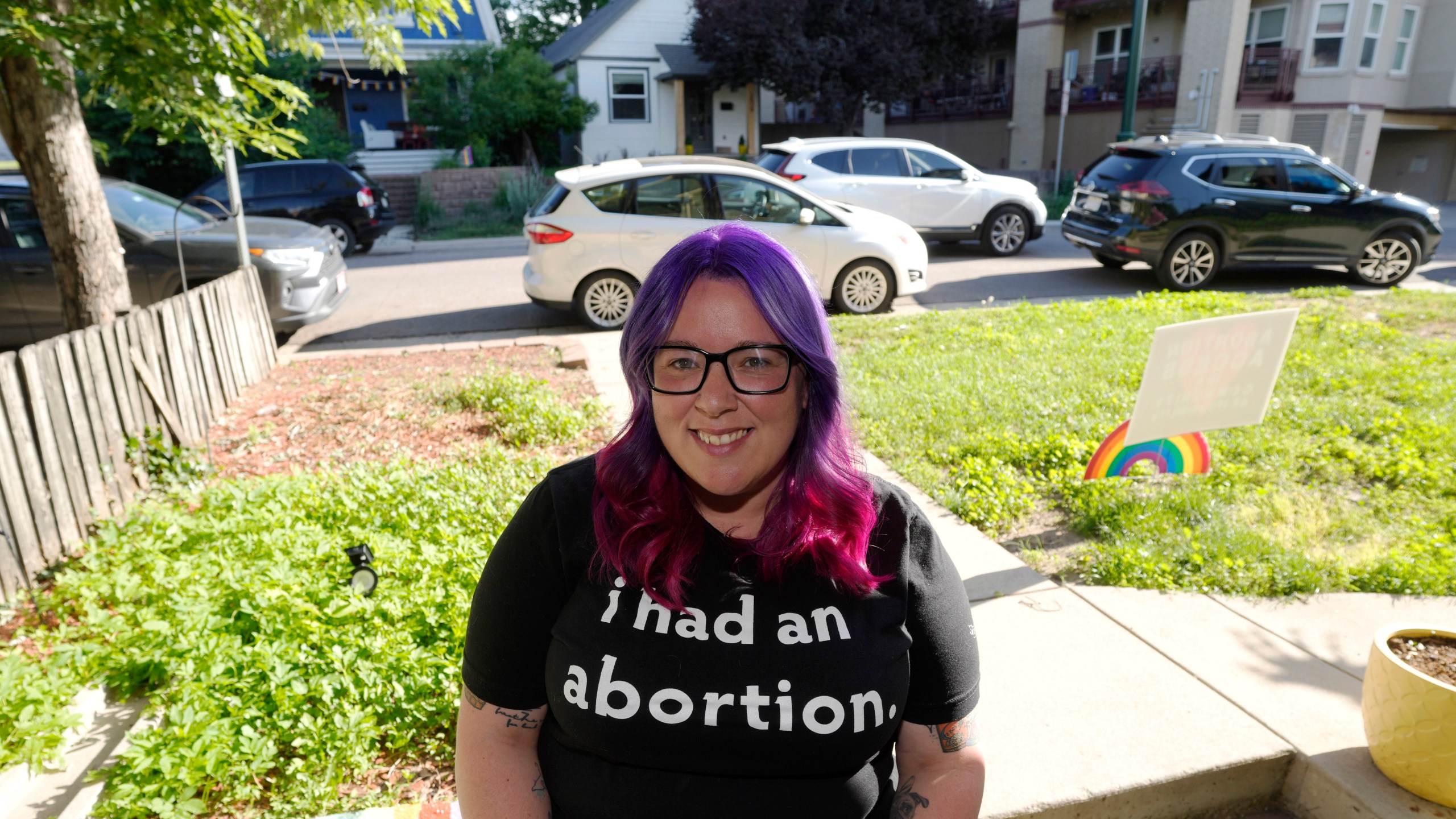 Leah Dean, a native of the Texas Panhandle, poses outside her home Monday, July 3, 2023, in Denver. Americans are segregating by their politics at a rapid clip, helping fuel the greatest divide between the states in modern history. (AP Photo/David Zalubowski)