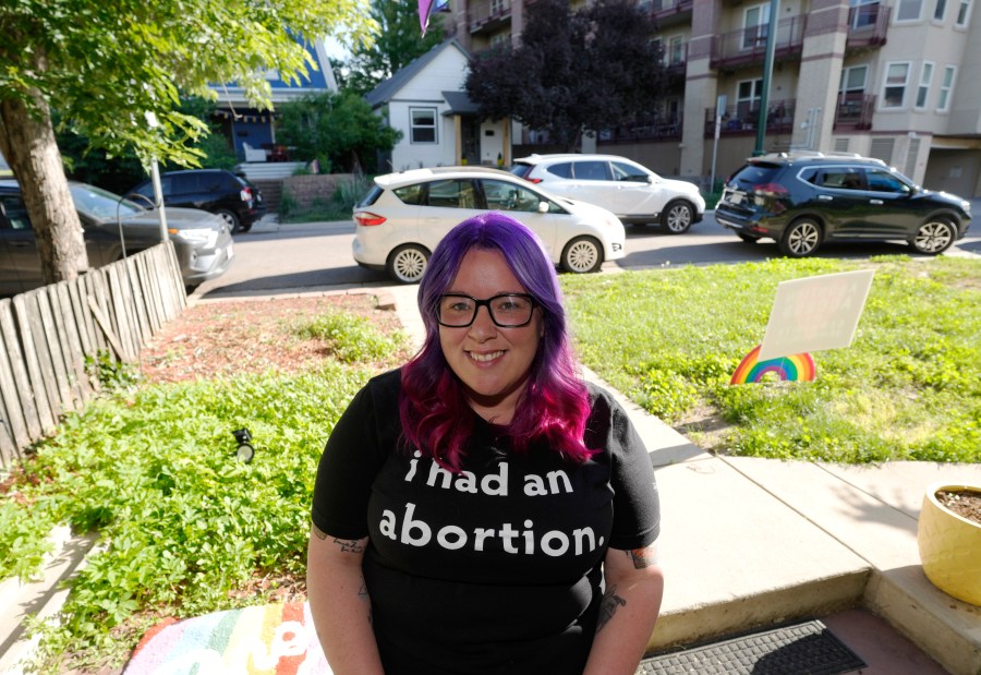 Leah Dean, a native of the Texas Panhandle, poses outside her home Monday, July 3, 2023, in Denver. Americans are segregating by their politics at a rapid clip, helping fuel the greatest divide between the states in modern history. (AP Photo/David Zalubowski)