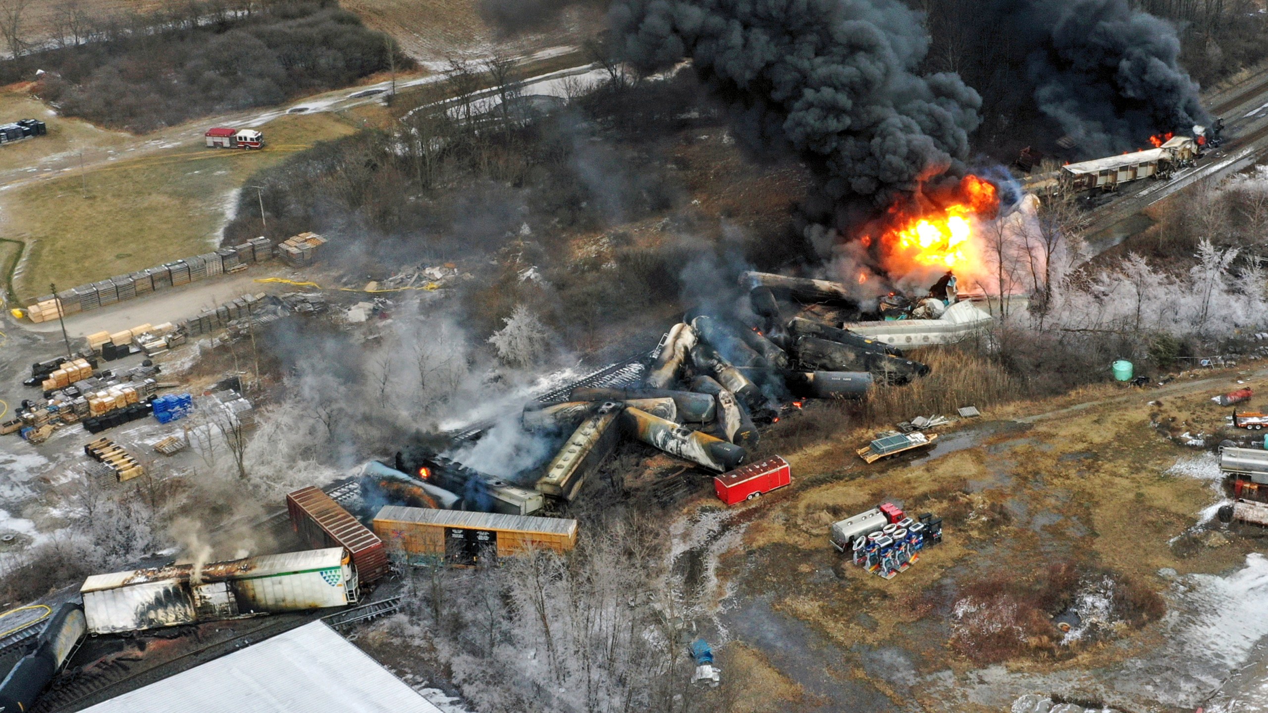 FILE - In this photo taken with a drone, portions of a Norfolk Southern freight train that derailed the previous night in East Palestine, Ohio, remain on fire at mid-day, Feb. 4, 2023. Norfolk Southern says the owner of the rail car that caused the fiery Ohio derailment in February failed to properly maintain it in the years before the crash, and the railroad wants to make sure that company and the owners of the other cars involved pay their fair share of the costs. The railroad filed a complaint Friday, June 30, against all the car owners and shippers responsible for the hazardous chemicals that spilled in the derailment. (AP Photo/Gene J. Puskar, File)