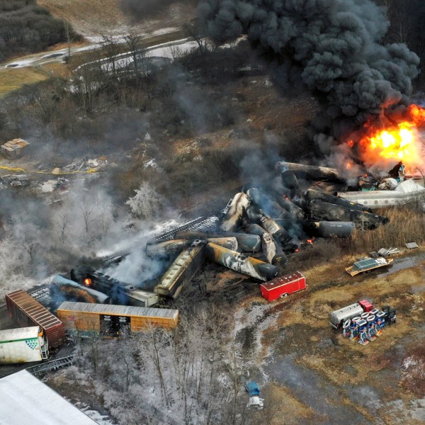 FILE - In this photo taken with a drone, portions of a Norfolk Southern freight train that derailed the previous night in East Palestine, Ohio, remain on fire at mid-day, Feb. 4, 2023. Norfolk Southern says the owner of the rail car that caused the fiery Ohio derailment in February failed to properly maintain it in the years before the crash, and the railroad wants to make sure that company and the owners of the other cars involved pay their fair share of the costs. The railroad filed a complaint Friday, June 30, against all the car owners and shippers responsible for the hazardous chemicals that spilled in the derailment. (AP Photo/Gene J. Puskar, File)