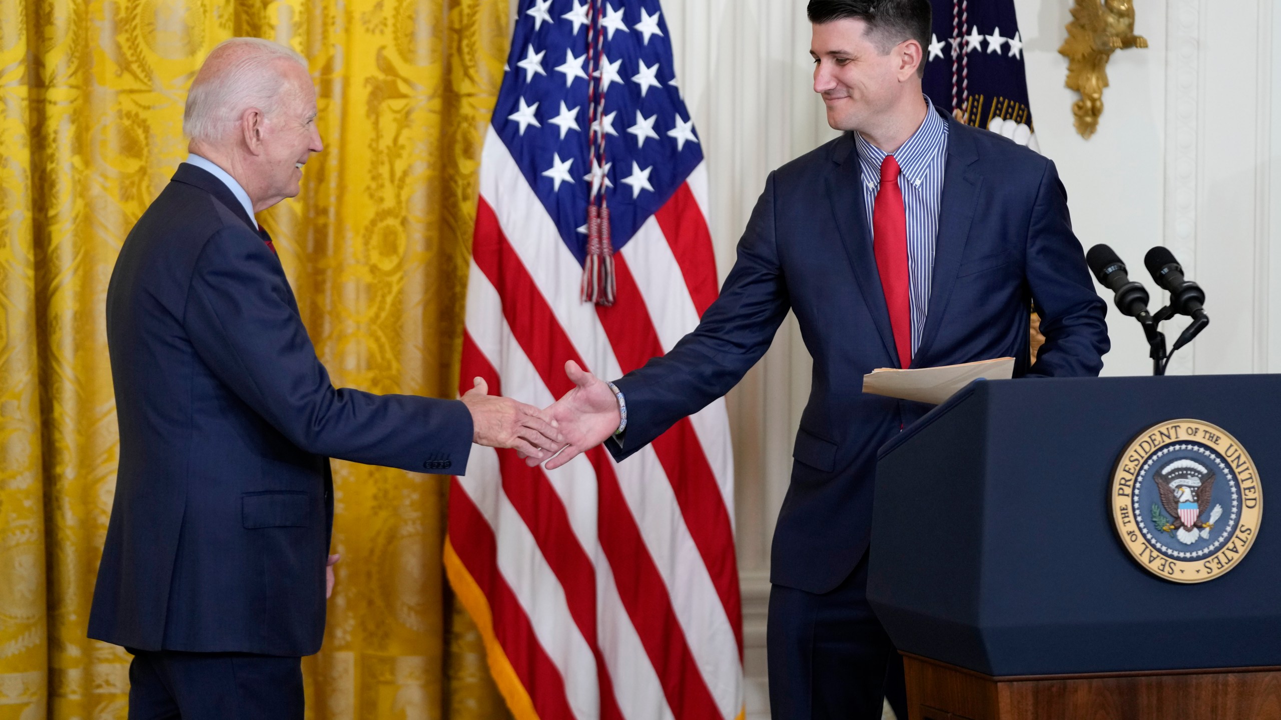 President Joe Biden shakes hands with Cory Dowd after he was introduced to speak during an event about lowering health care costs, Friday, July 7, 2023, in the East Room of the White House in Washington. (AP Photo/Patrick Semansky)