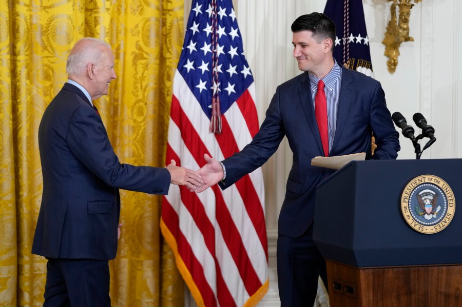 President Joe Biden shakes hands with Cory Dowd after he was introduced to speak during an event about lowering health care costs, Friday, July 7, 2023, in the East Room of the White House in Washington. (AP Photo/Patrick Semansky)