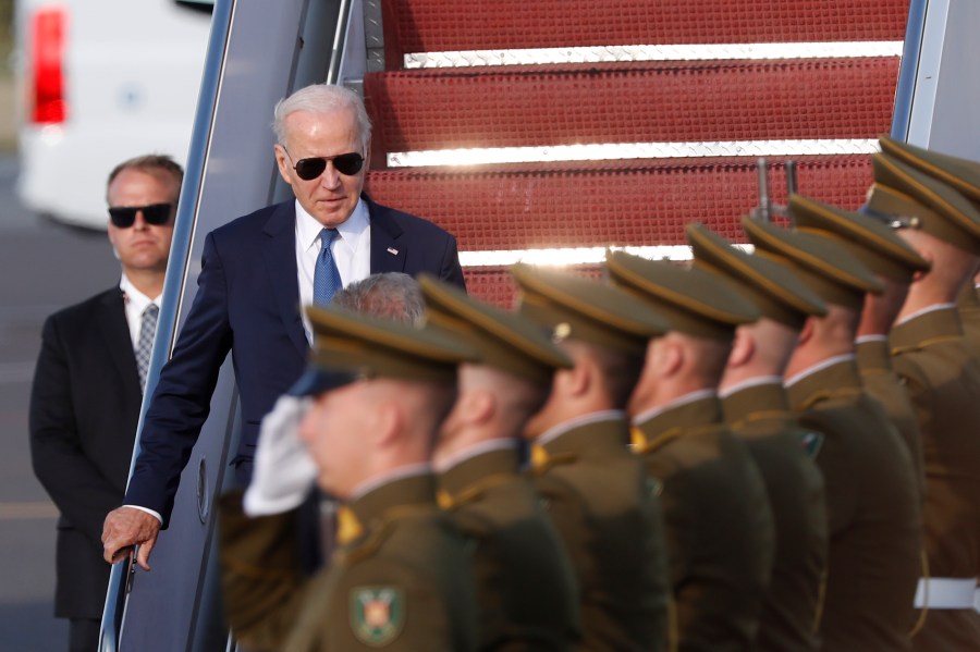 U.S. President Joe Biden, center, arrives at Vilnius airport ahead of a NATO summit in Vilnius, Lithuania, Monday, July 10, 2023. Russia's war on Ukraine will top the agenda when NATO leaders meet in the Lithuanian capital Vilnius on Tuesday and Wednesday. (AP Photo/Mindaugas Kulbis)