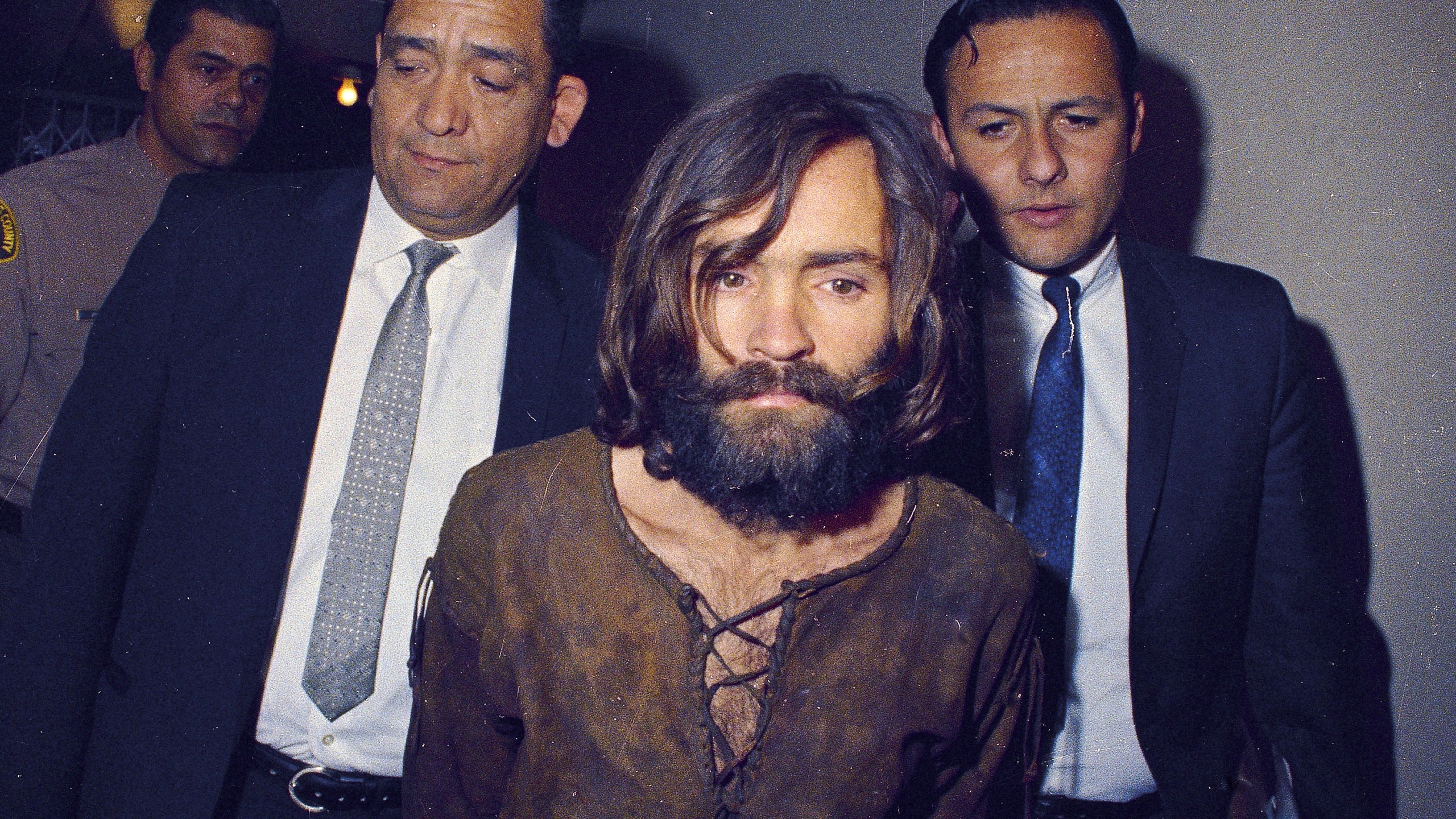 FILE - Charles Manson is escorted to his arraignment on conspiracy-murder charges in connection with the Sharon Tate murder case in Los Angeles in 1969. Leslie Van Houten, one of Manson's followers, was released from prison on parole on Tuesday, July 11, 2023. (AP Photo/File)